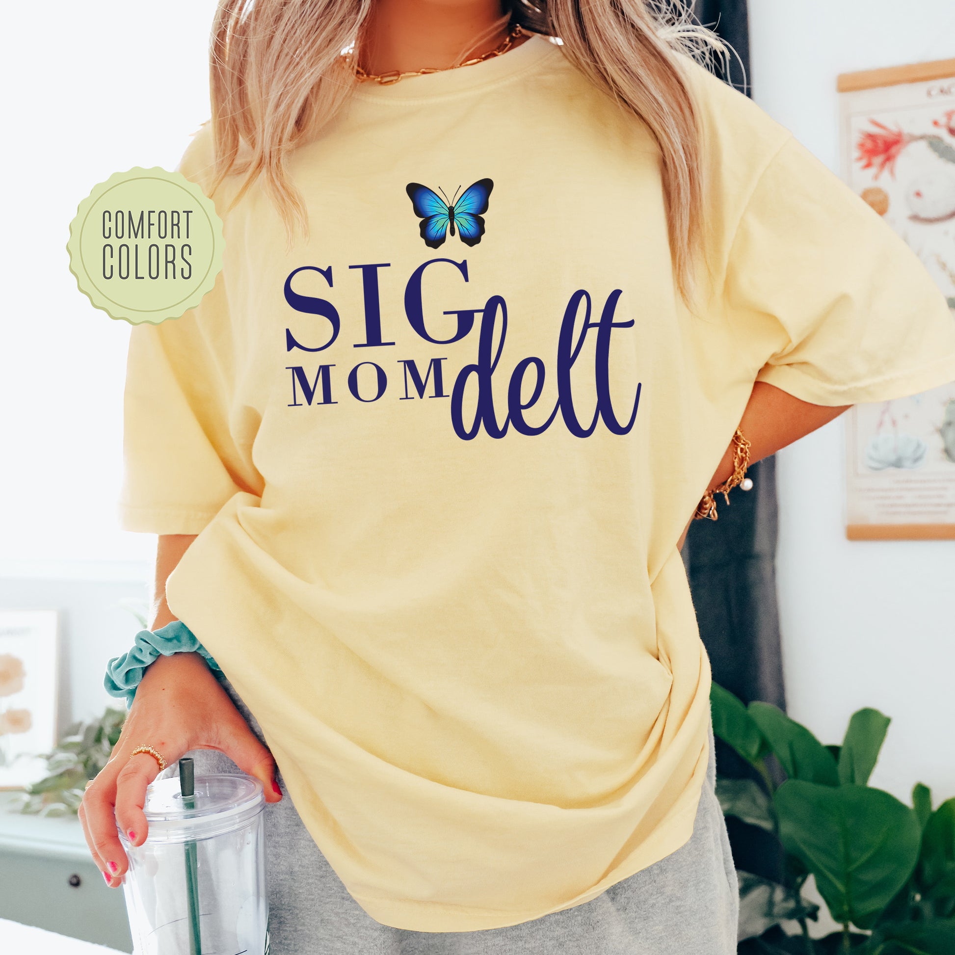 a woman wearing a yellow shirt with a butterfly on it
