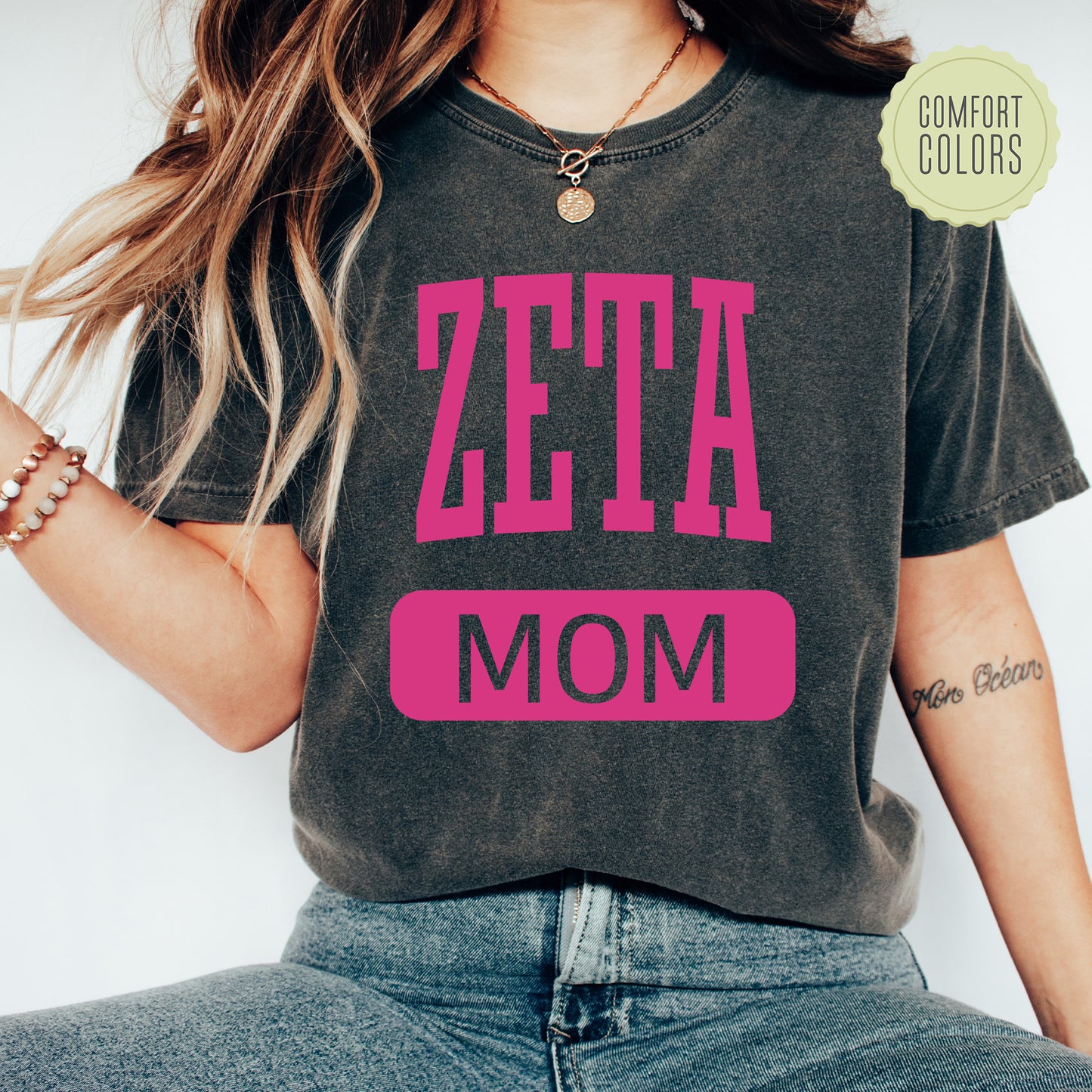 a woman wearing a t - shirt that says zeta mom