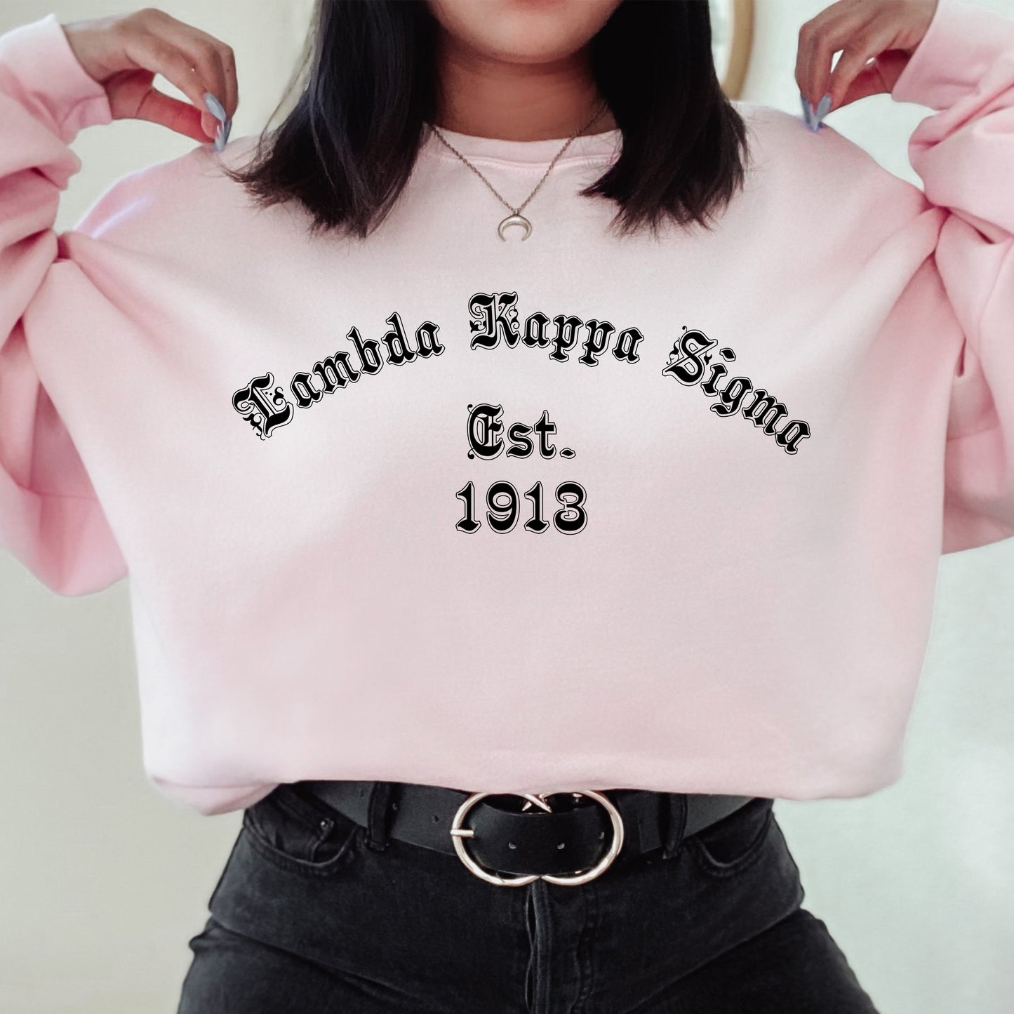 a woman is holding a pink sweatshirt with the words grandma henry sign on it