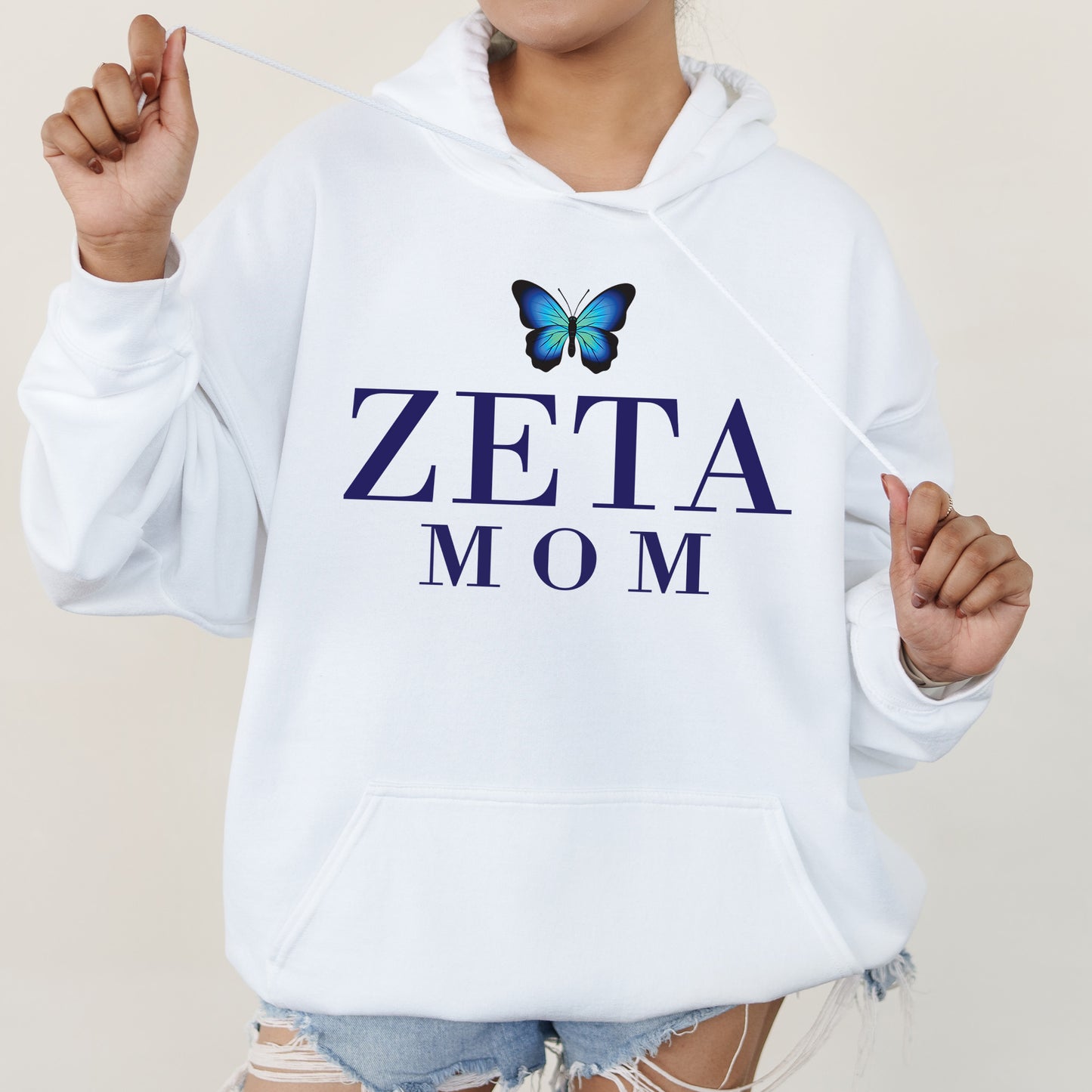 a woman wearing a white hoodie with a butterfly on it