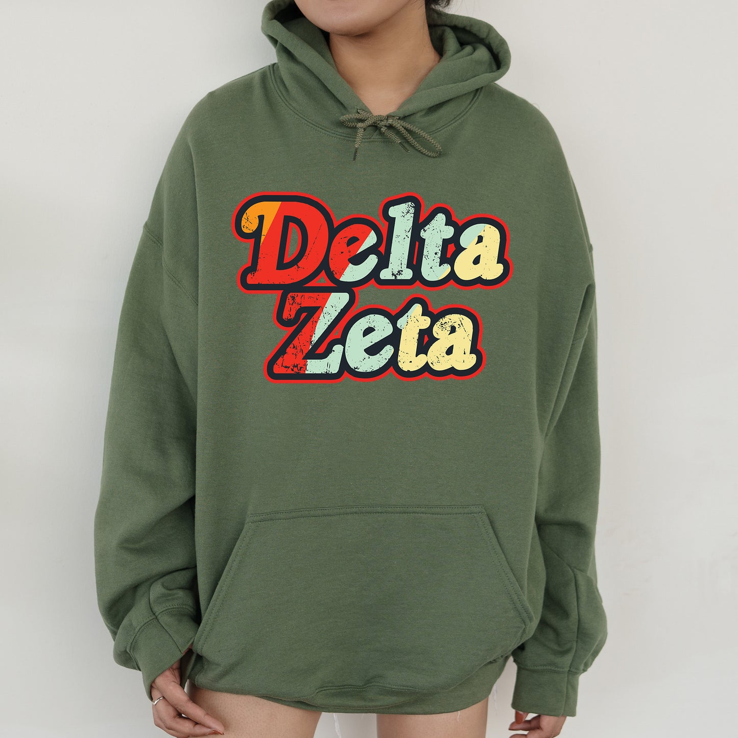 a woman wearing a green delta zeta hoodie