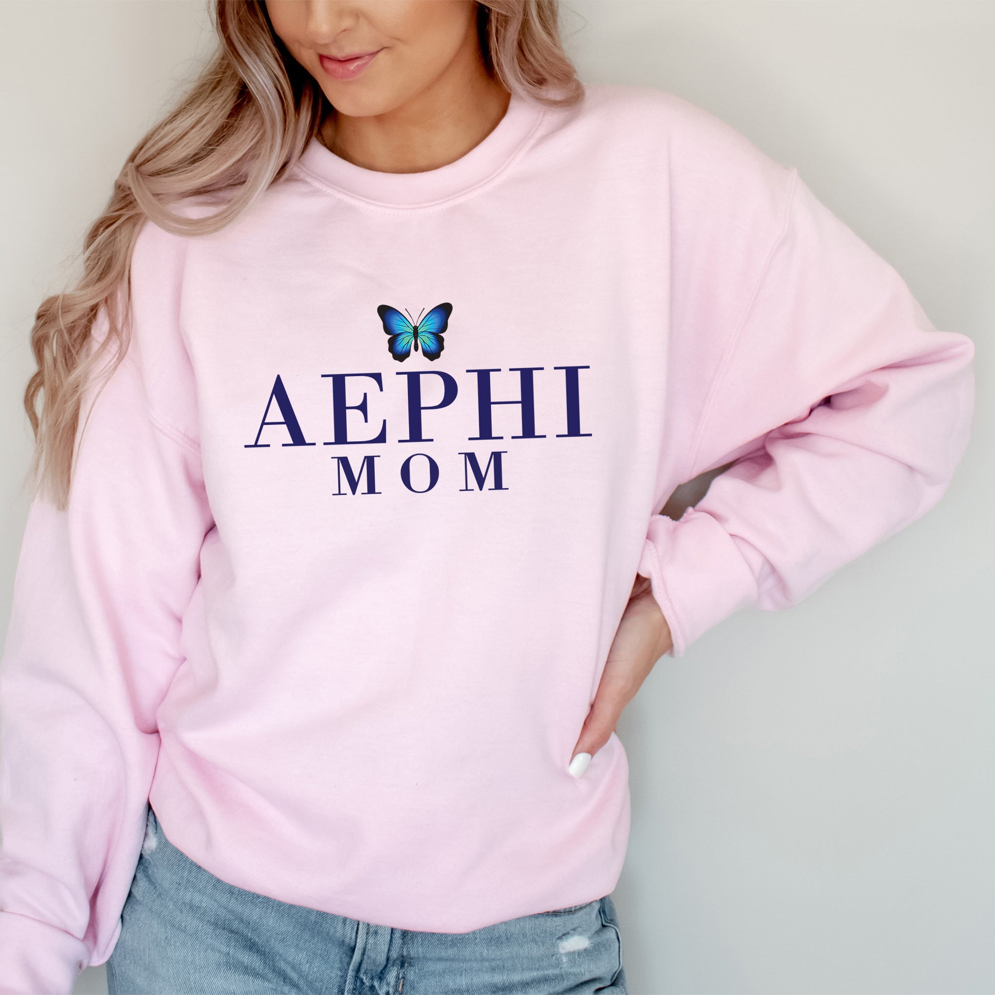 a woman wearing a pink sweatshirt with a butterfly on it