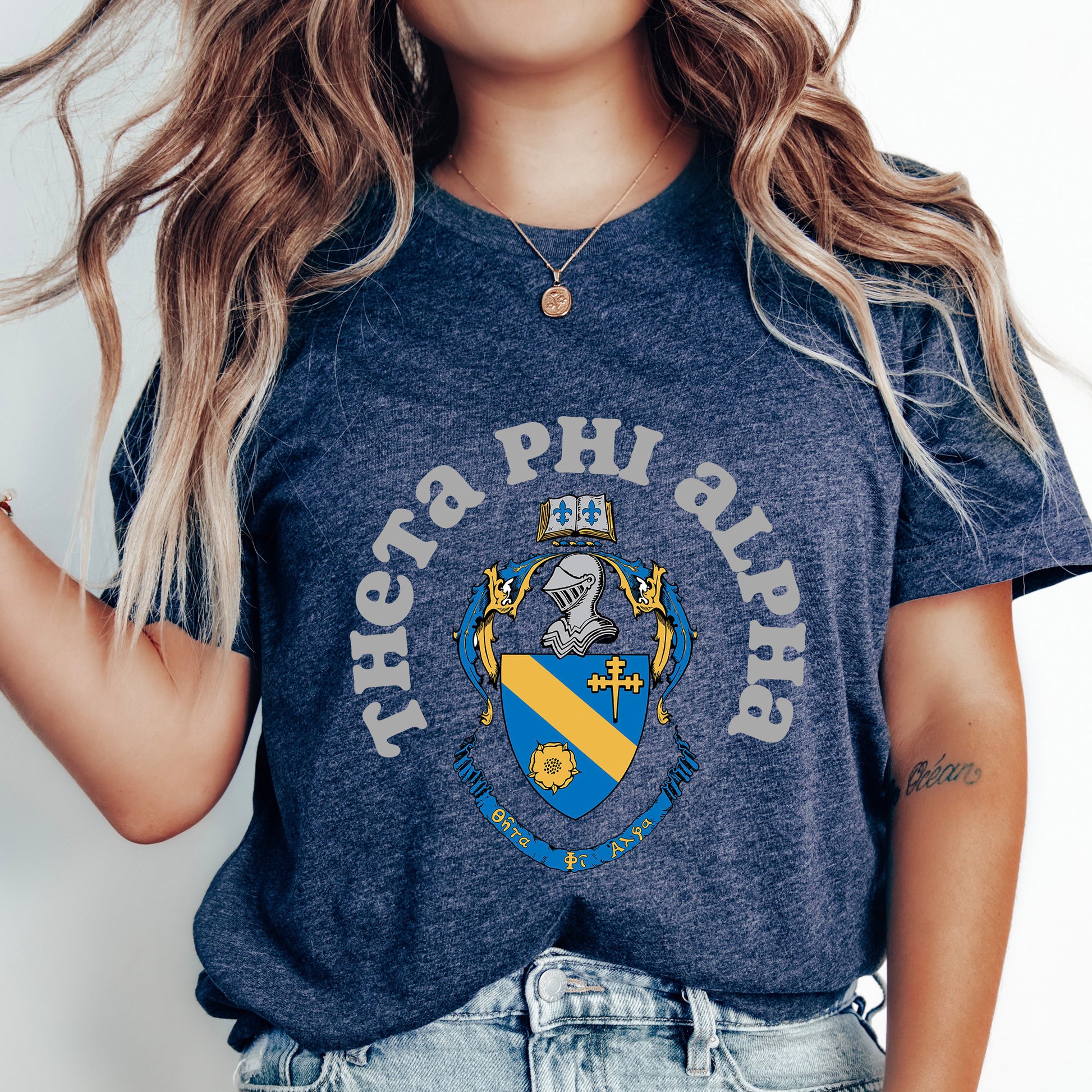 a woman wearing a phi phi phi shirt