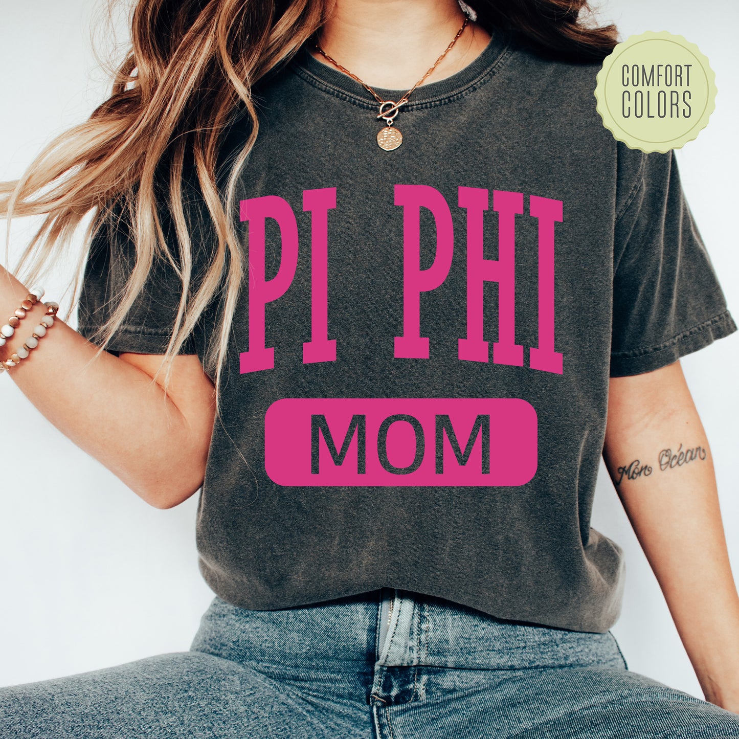 a woman wearing a shirt that says pi phi mom