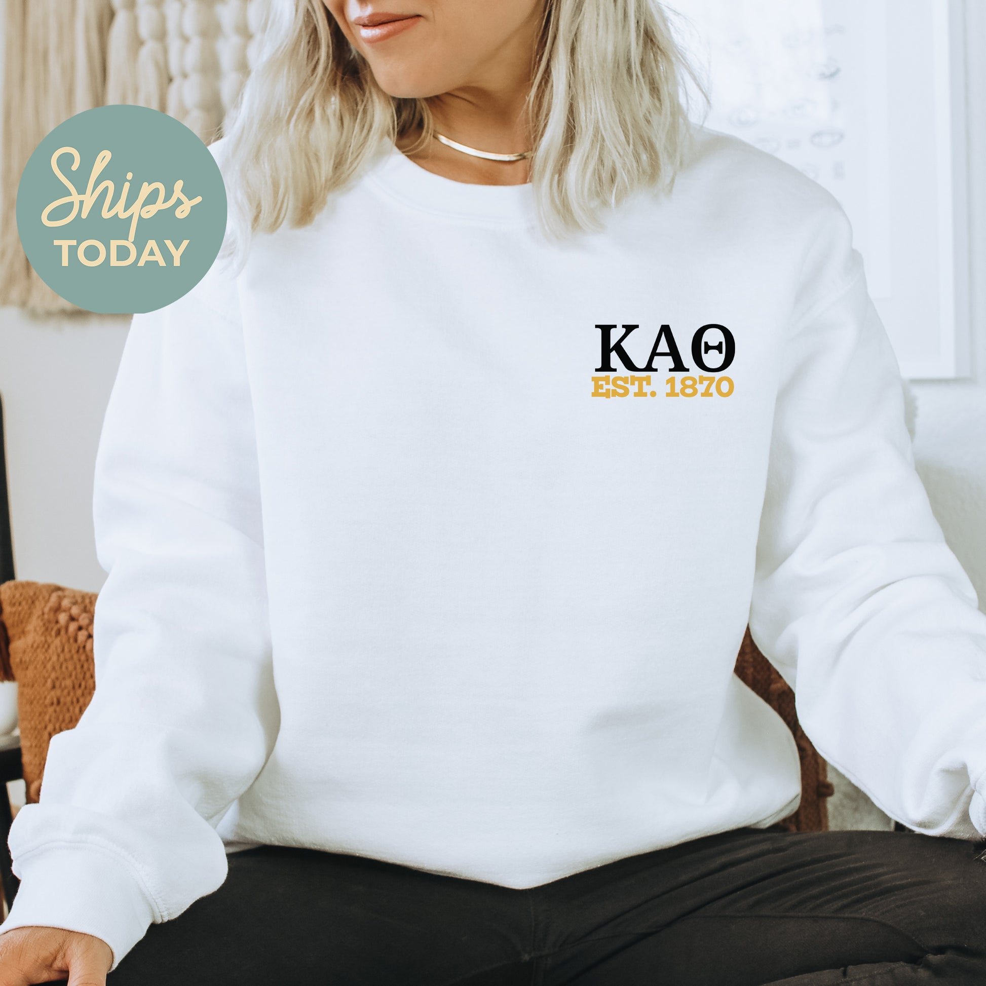 a woman sitting on a chair wearing a white sweatshirt