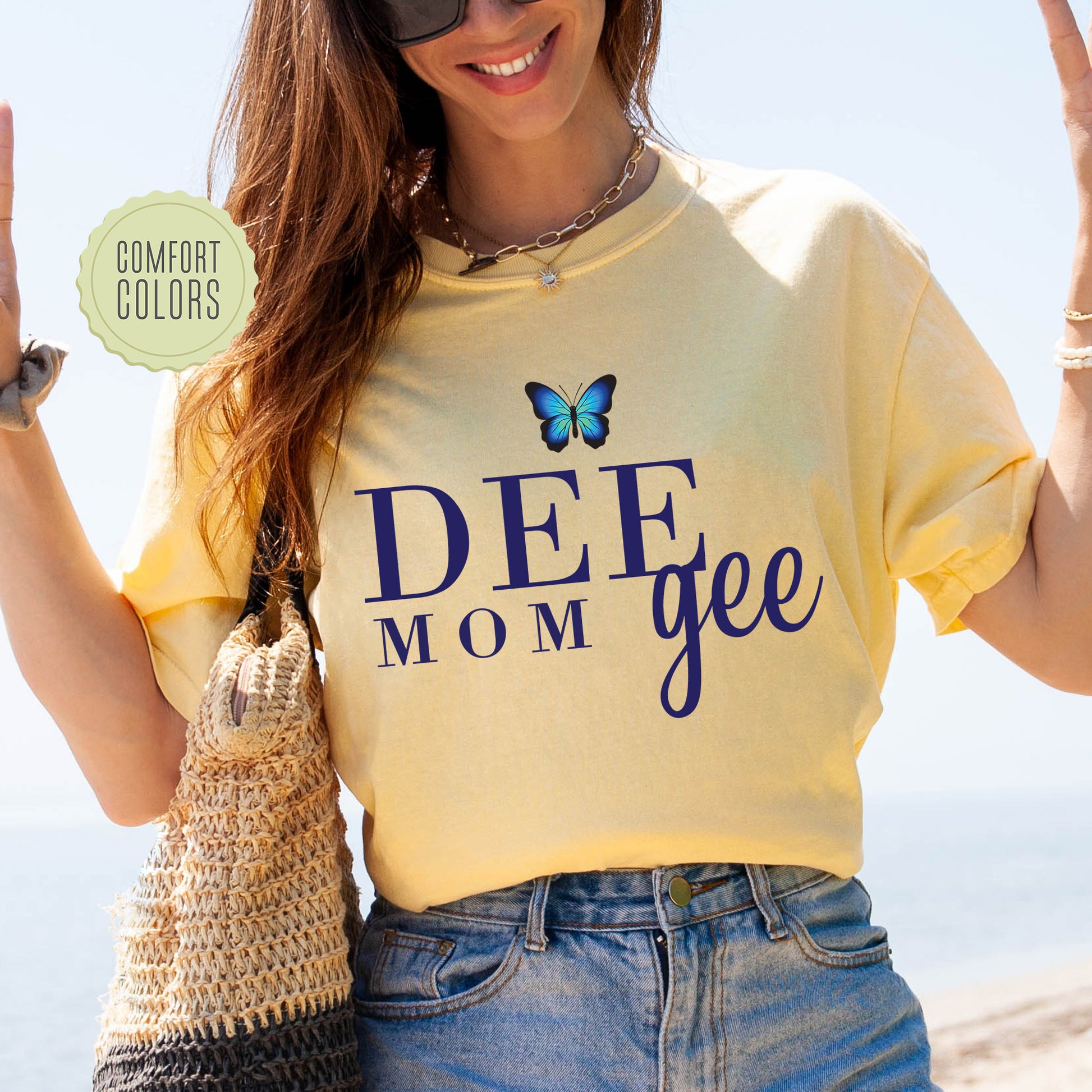 a woman in a yellow shirt holding up a peace sign