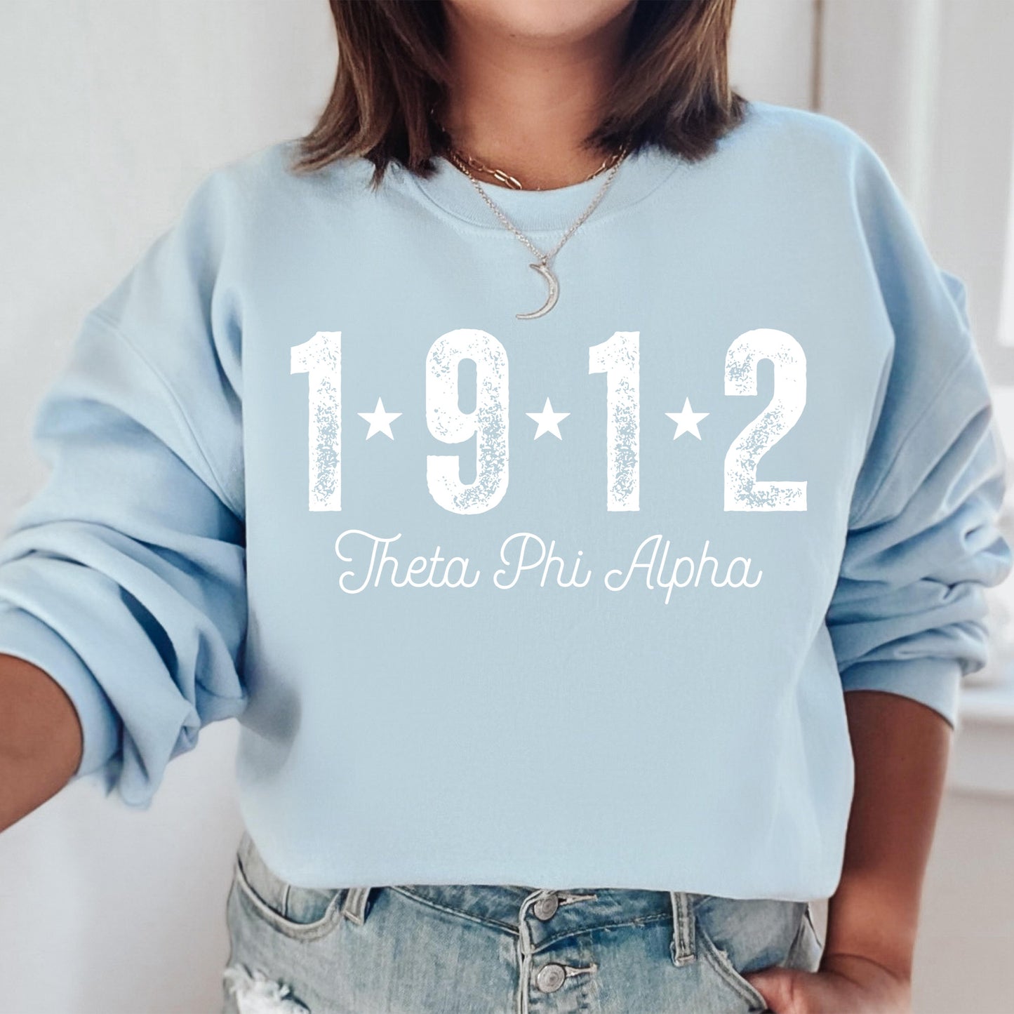 a woman wearing a blue sweatshirt with the year 1911 printed on it