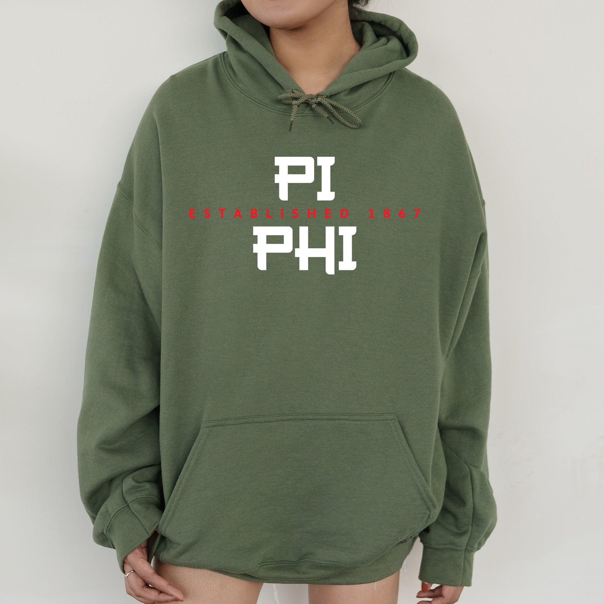 a person wearing a green hoodie with the word phi printed on it