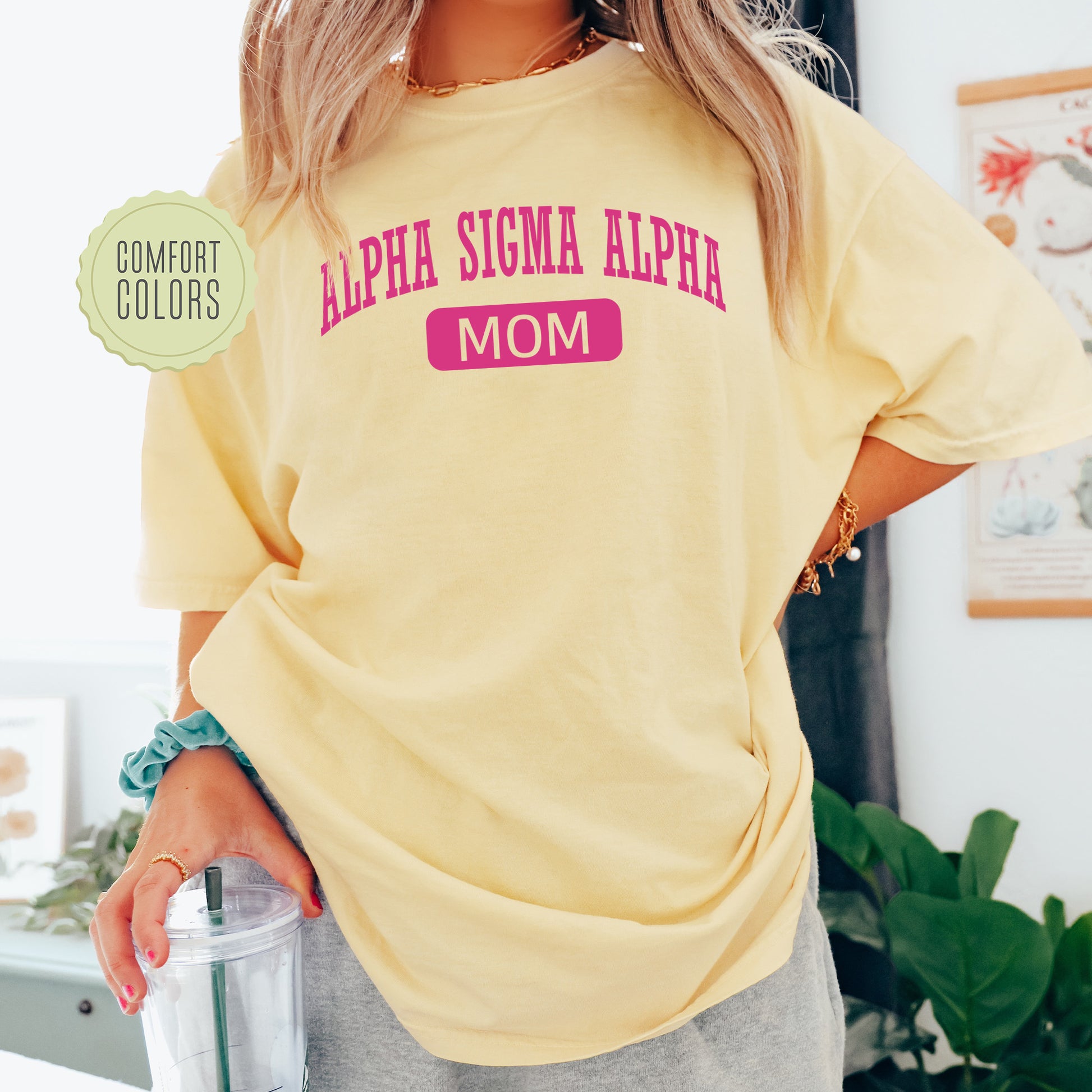a woman in a yellow shirt holding a blender