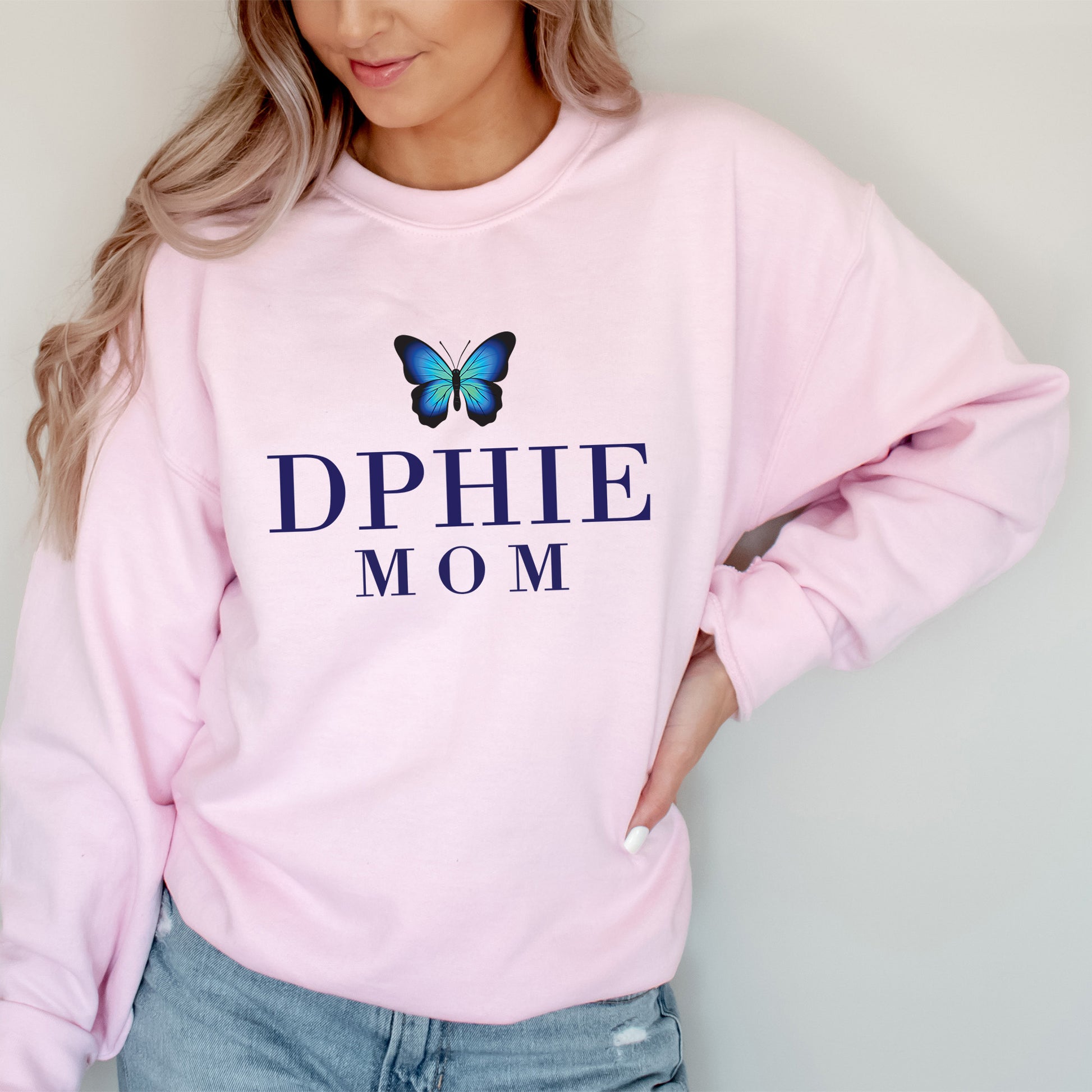 a woman wearing a pink sweatshirt with a blue butterfly on it