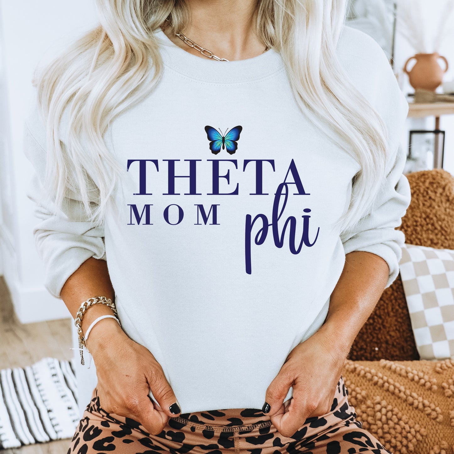 a woman wearing a sweatshirt that says,'thea mom phil '
