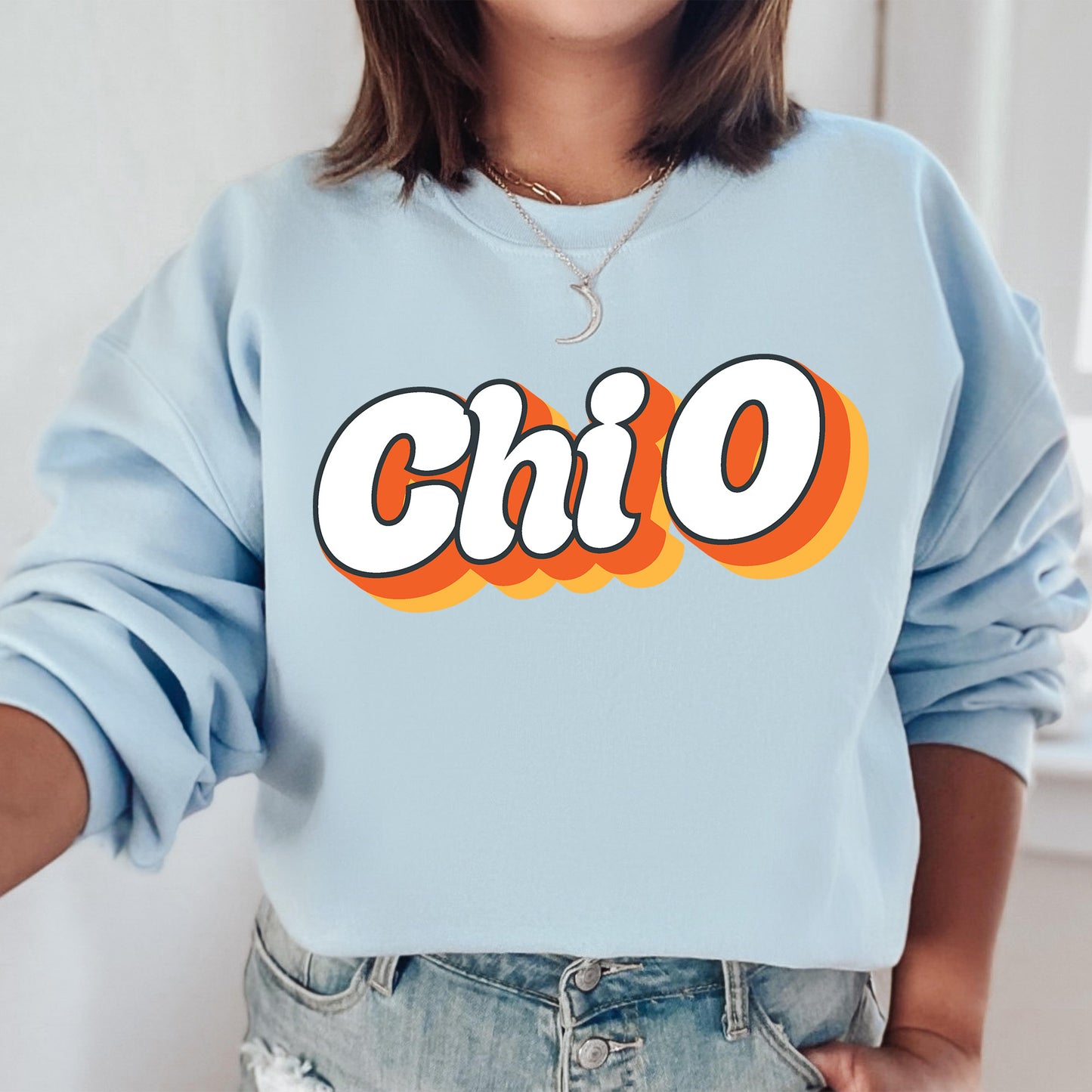 a woman wearing a blue sweatshirt with the word chio printed on it