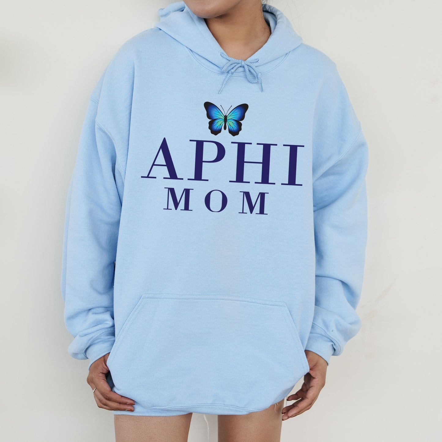 a woman wearing a blue hoodie with a butterfly on it