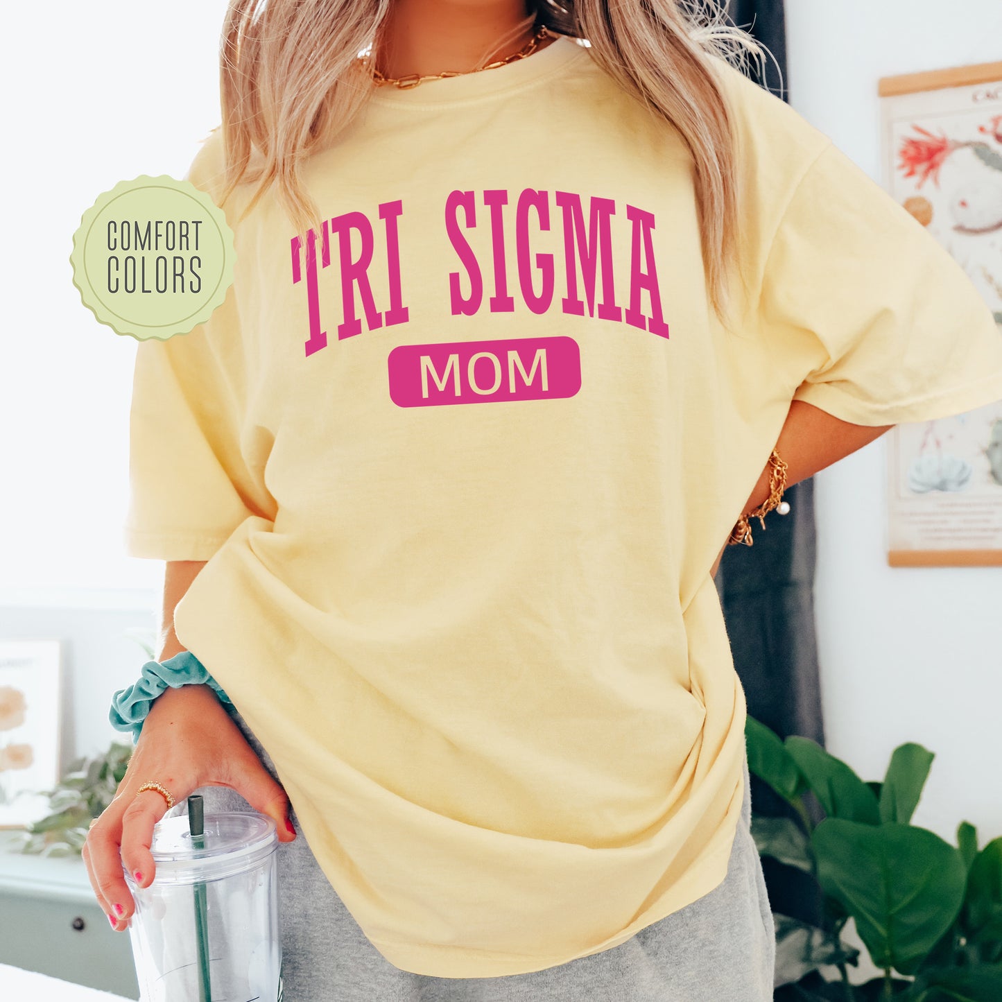 a woman in a yellow shirt holding a blender