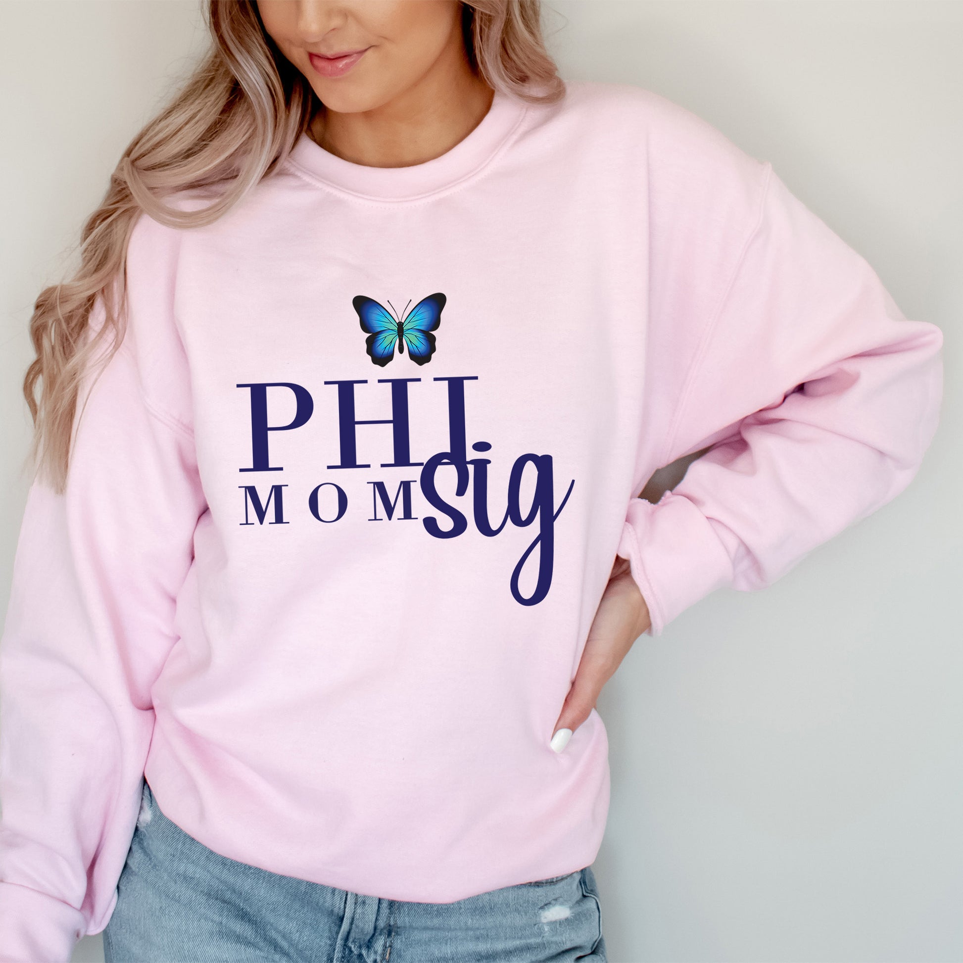 a woman wearing a pink sweatshirt with a butterfly on it