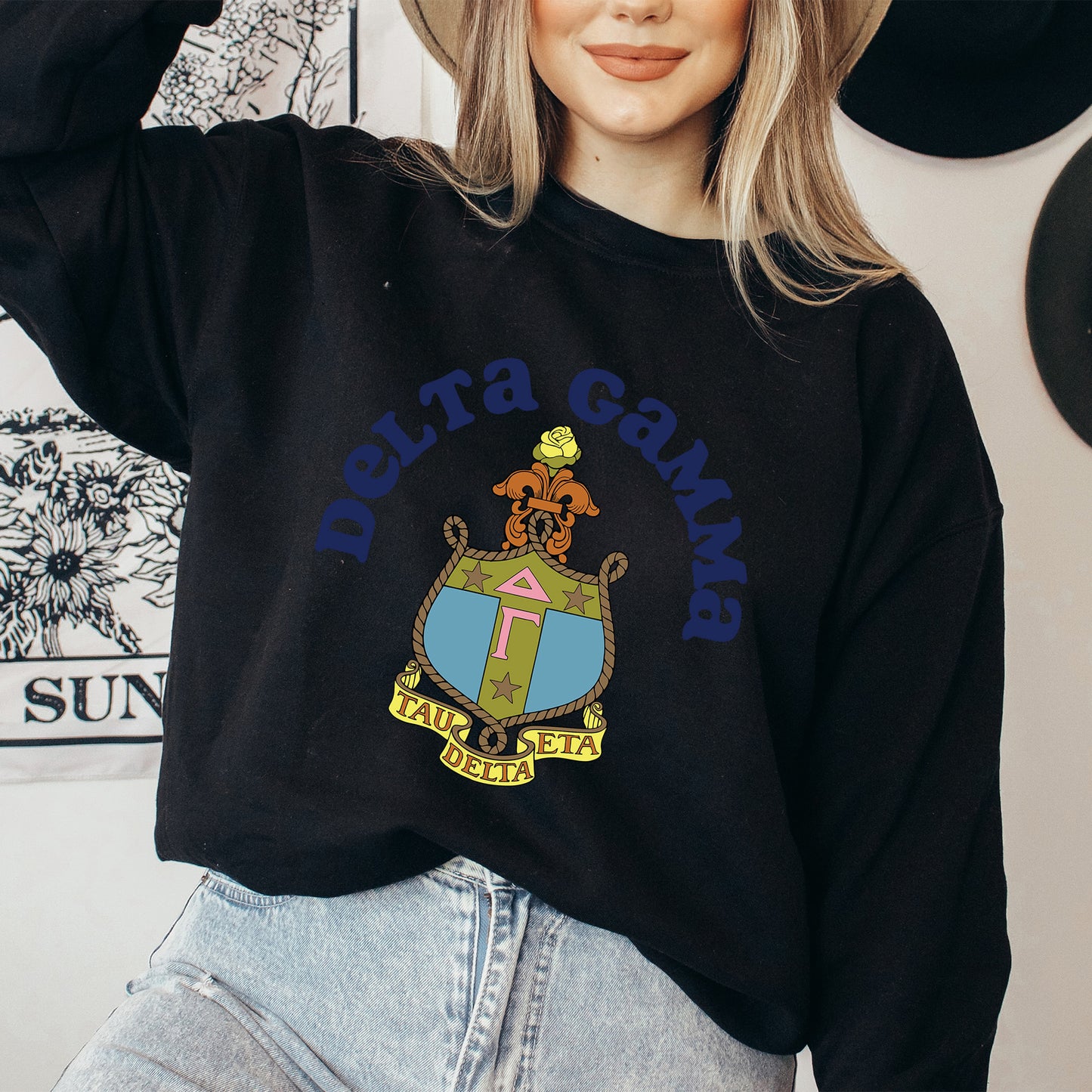 a woman wearing a hat and a black sweatshirt