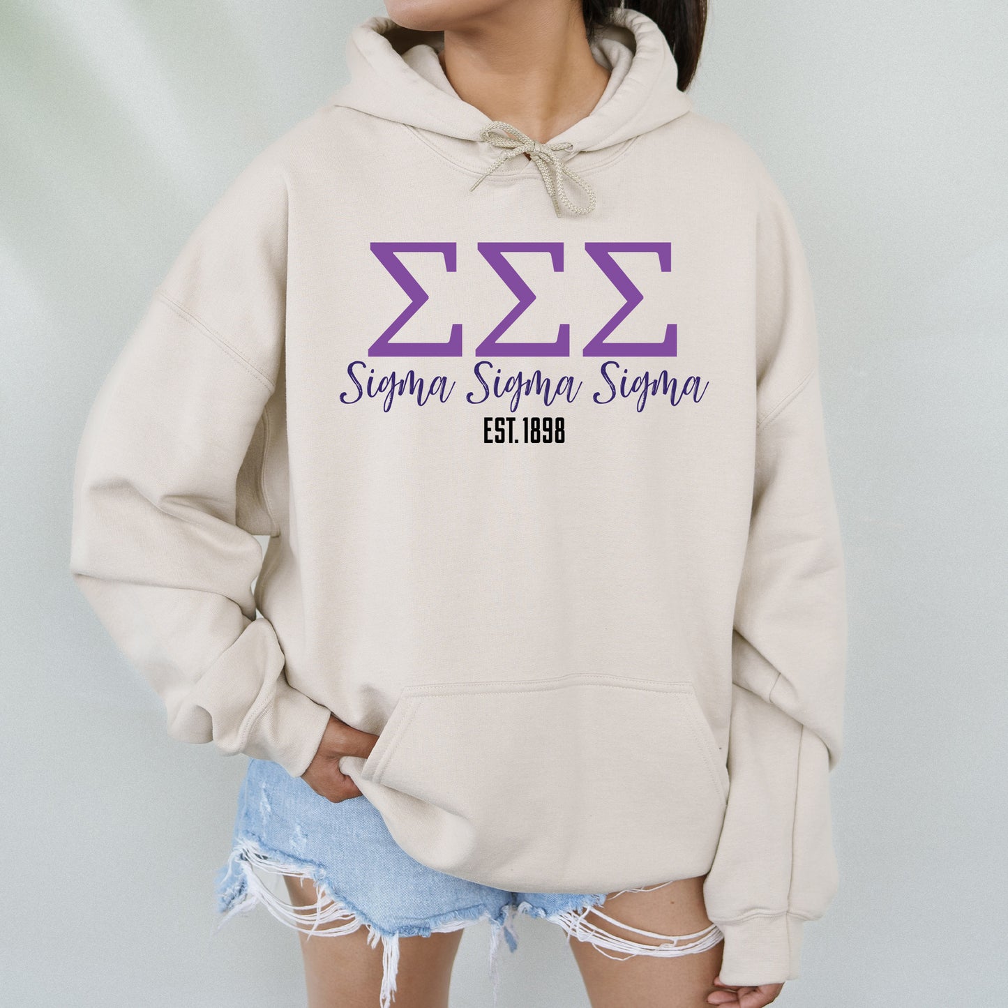 a woman wearing a white hoodie with purple letters on it