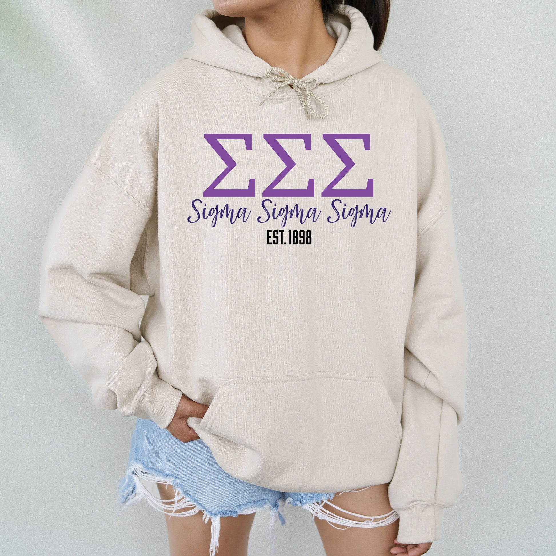 a woman wearing a white hoodie with purple letters on it