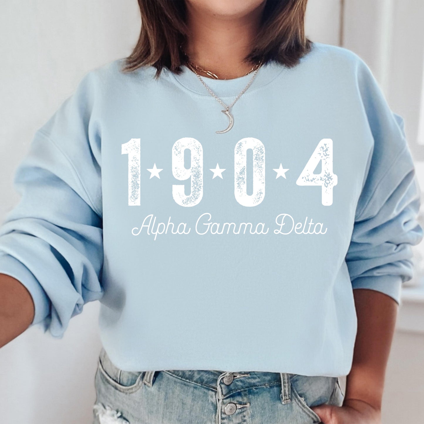 a woman wearing a blue sweatshirt with the year 1994 printed on it
