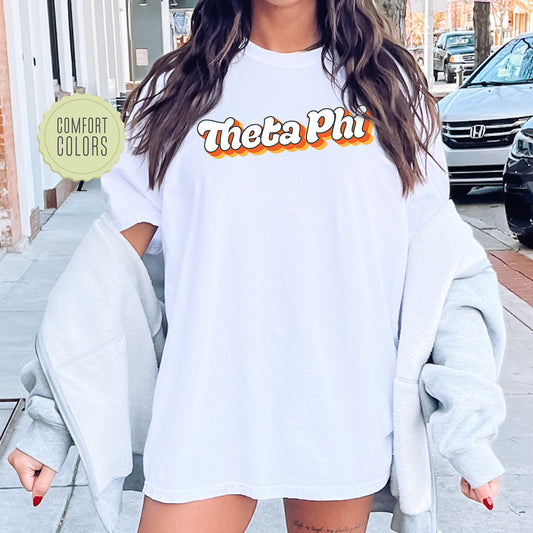 a woman wearing a white shirt with the words thea phi on it