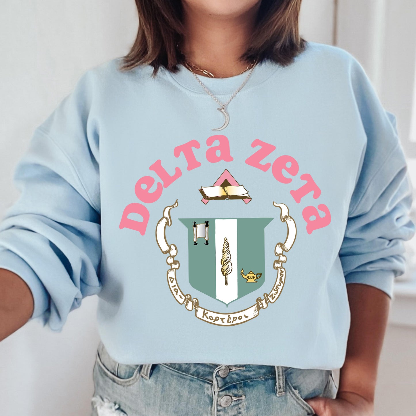 a woman wearing a blue sweatshirt with a crest on it