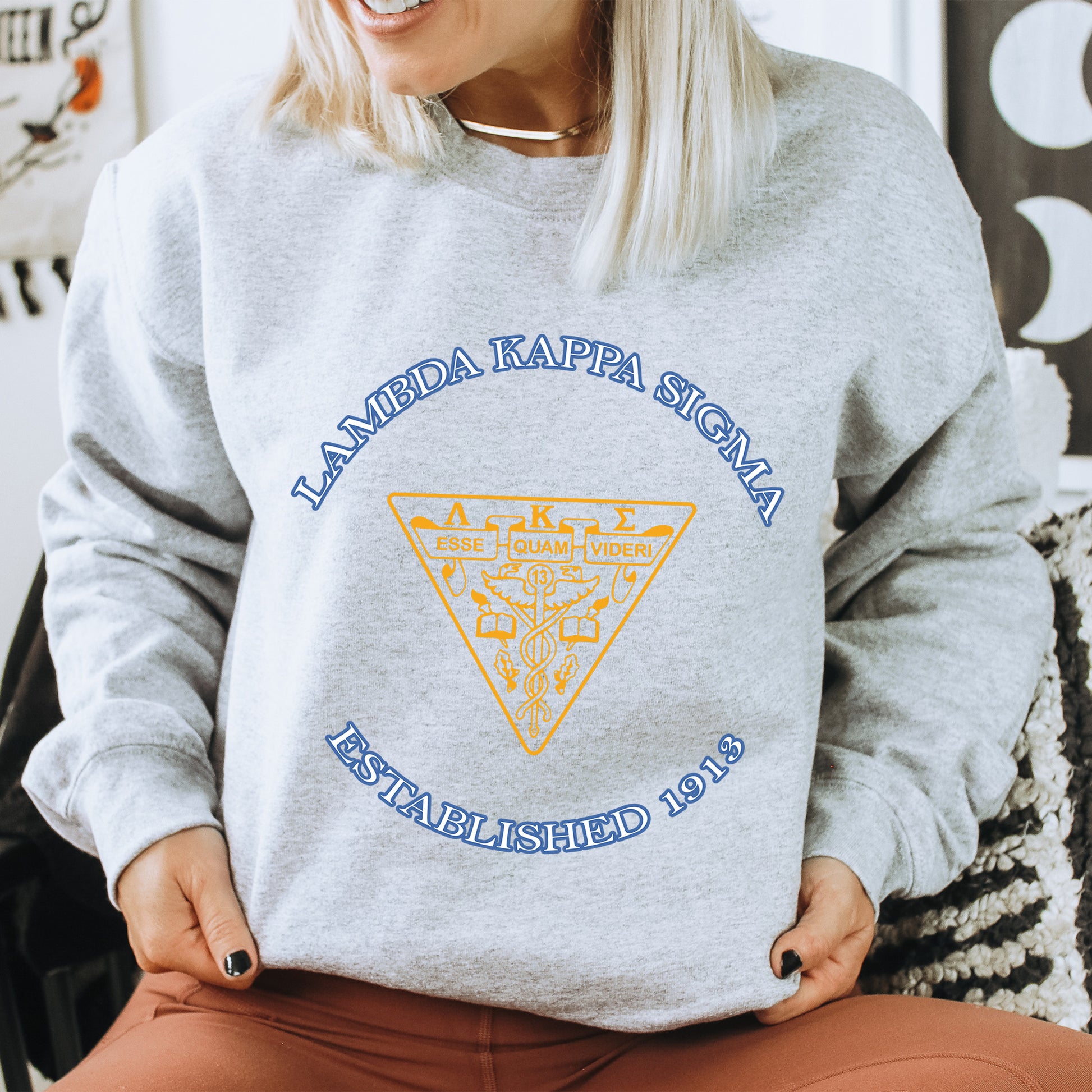 a woman sitting on a chair wearing a sweatshirt