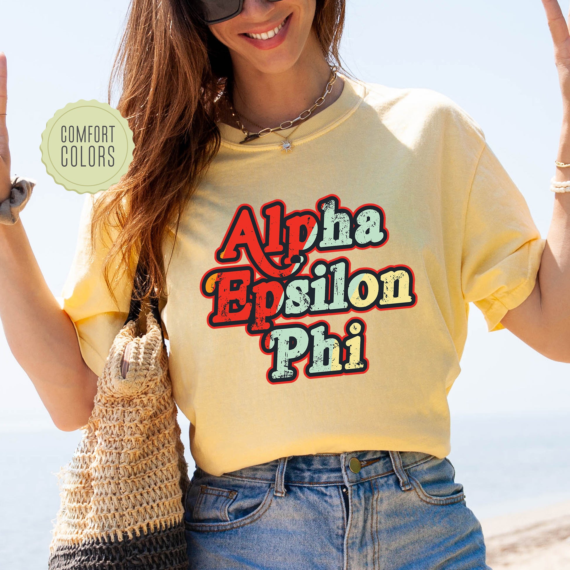 a woman wearing a yellow shirt with the words aloha epsilon phi