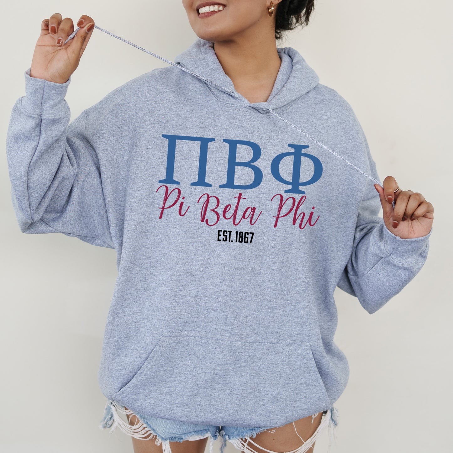 a woman in a blue hoodie holding a toothbrush