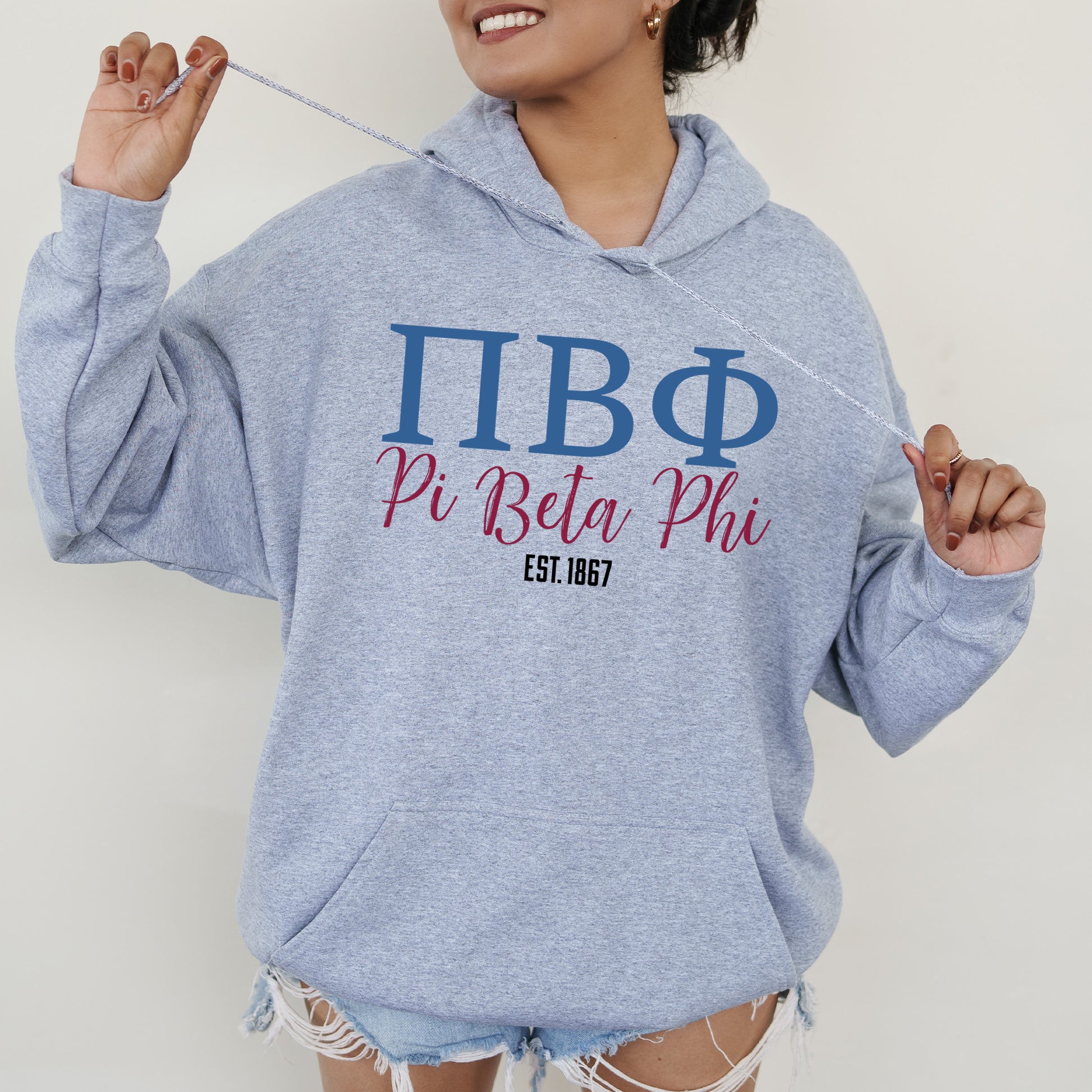 a woman in a blue hoodie holding a toothbrush