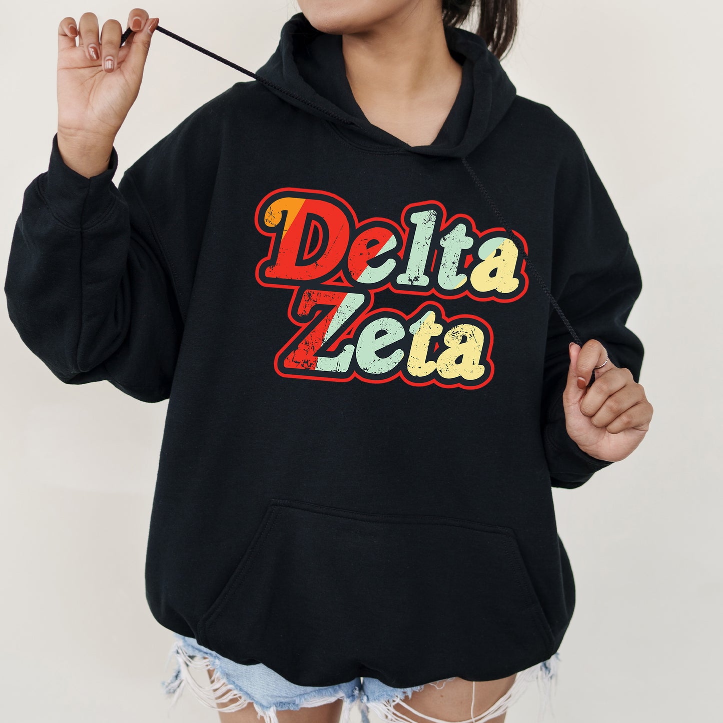 a woman wearing a black delta zeta hoodie