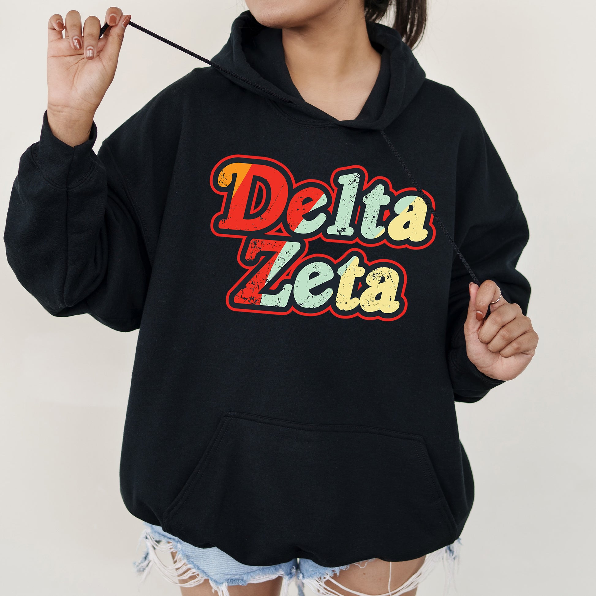 a woman wearing a black delta zeta hoodie
