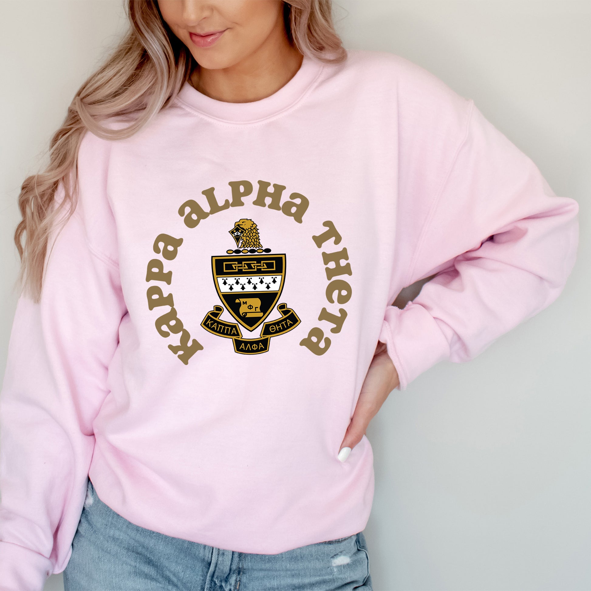 a woman wearing a pink sweatshirt and jeans