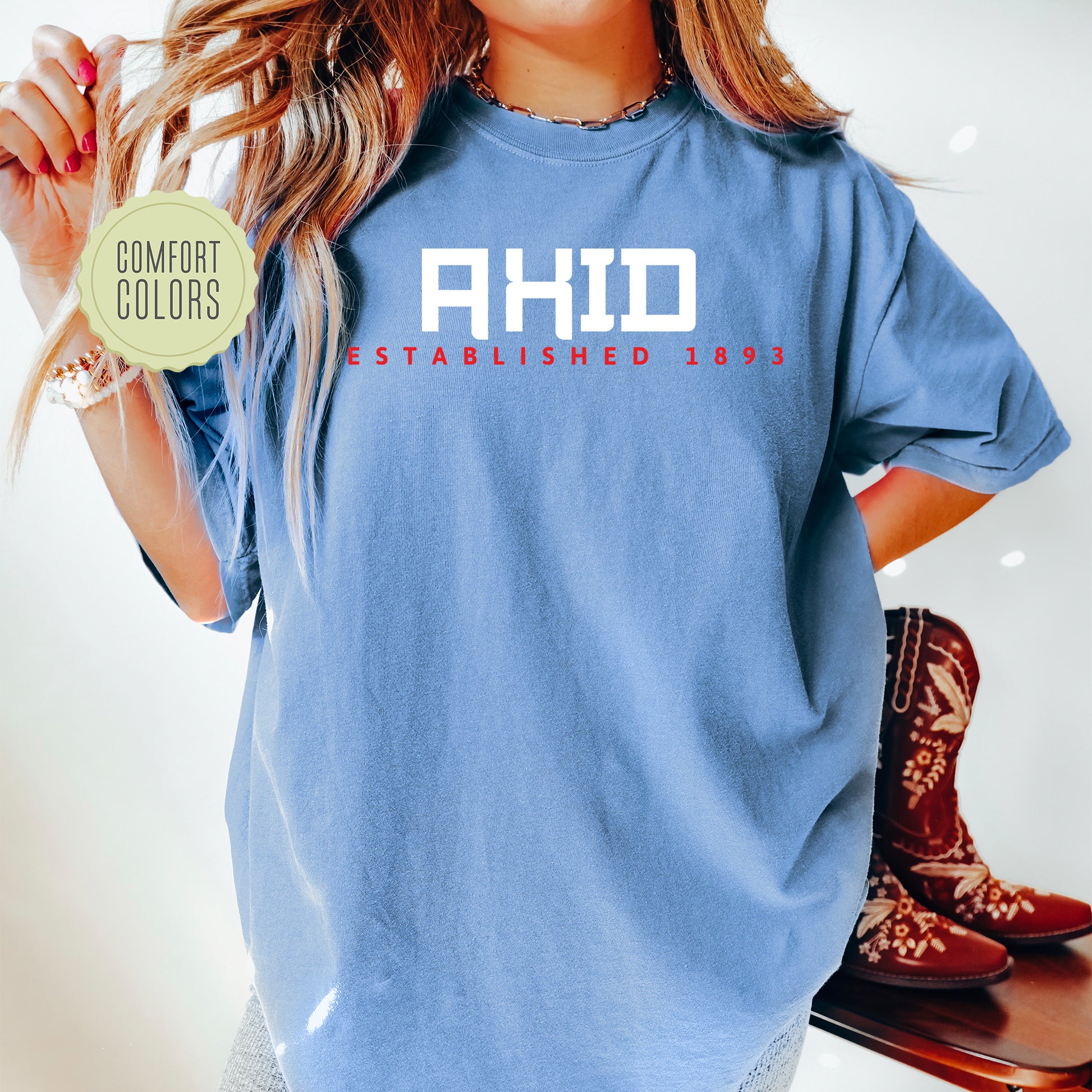 a woman in a blue shirt holding a skateboard