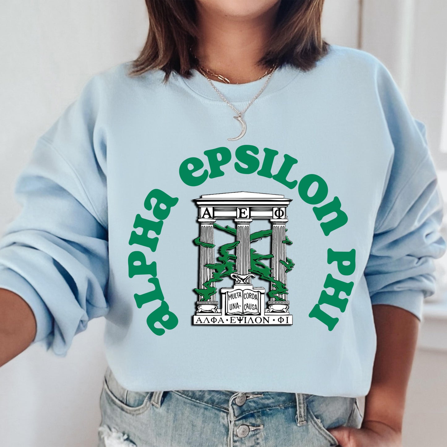 a woman wearing a blue sweatshirt with a green logo