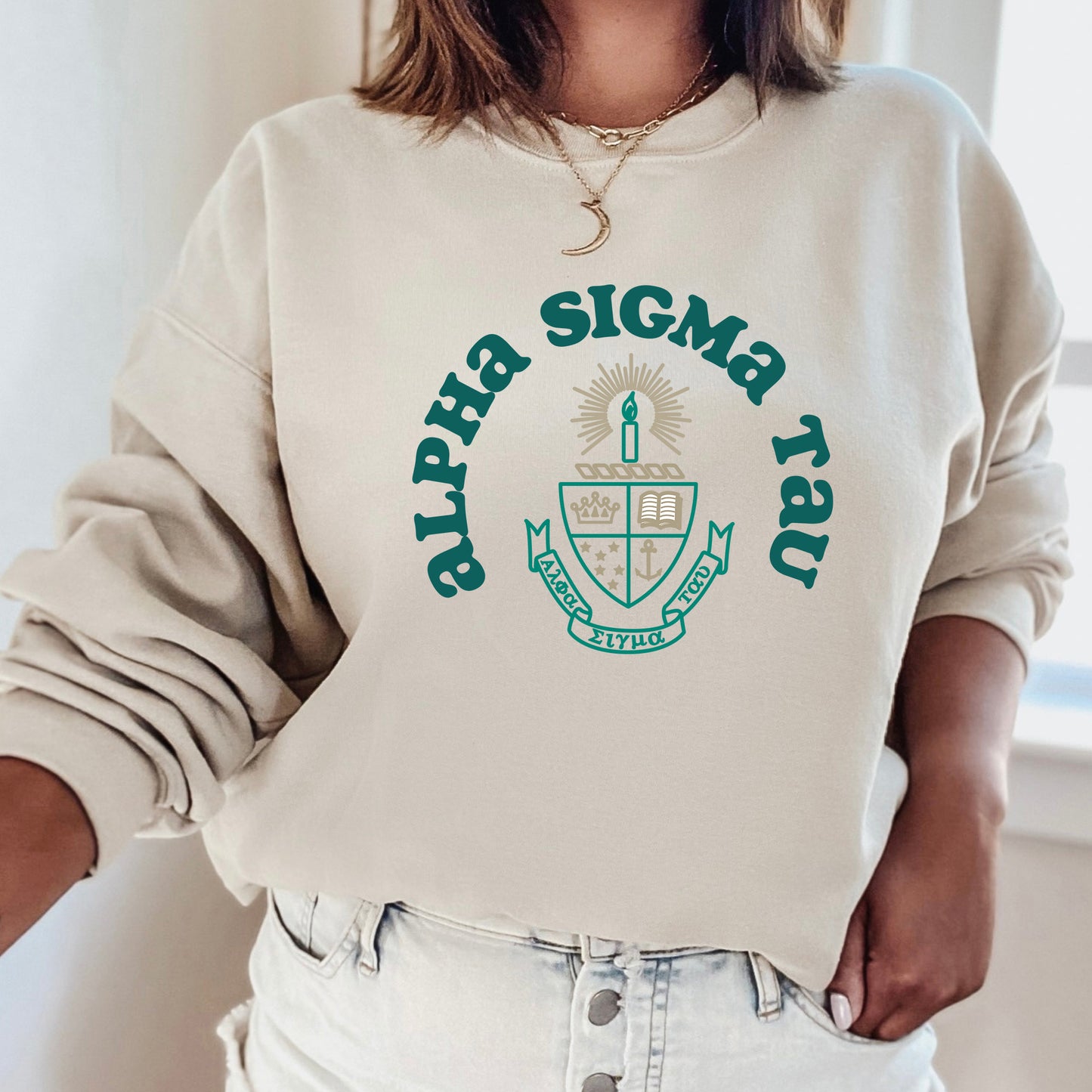 a woman wearing a sweatshirt with a crest on it