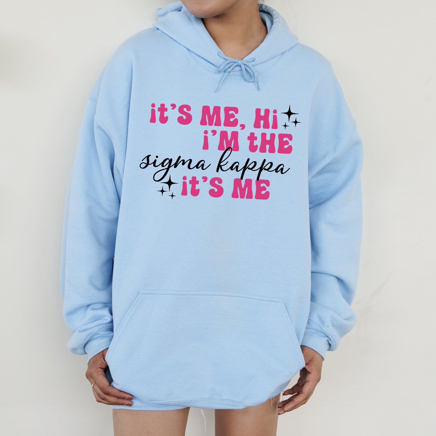 a woman wearing a blue hoodie that says it's me, i '