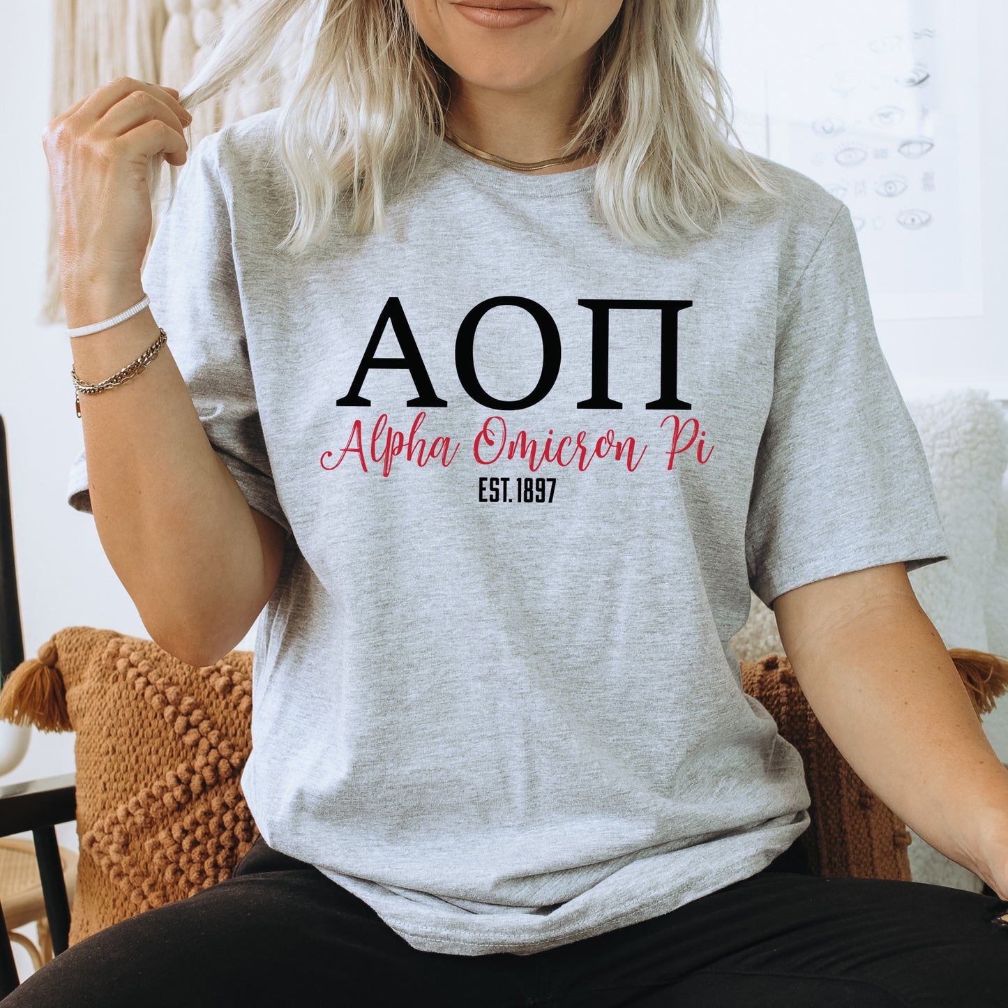 a woman sitting on a chair wearing a t - shirt with the word aoi