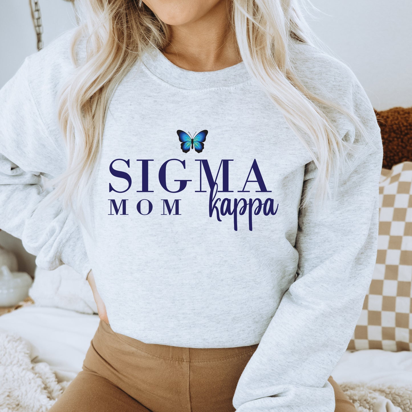 a woman wearing a sweatshirt that says stigma mom kappa