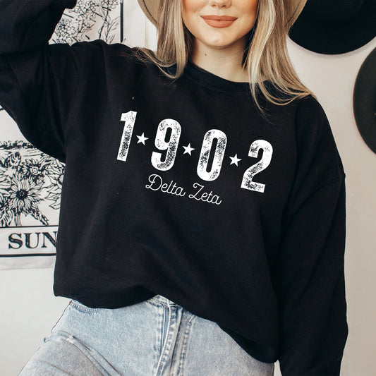 a woman wearing a black sweatshirt and hat