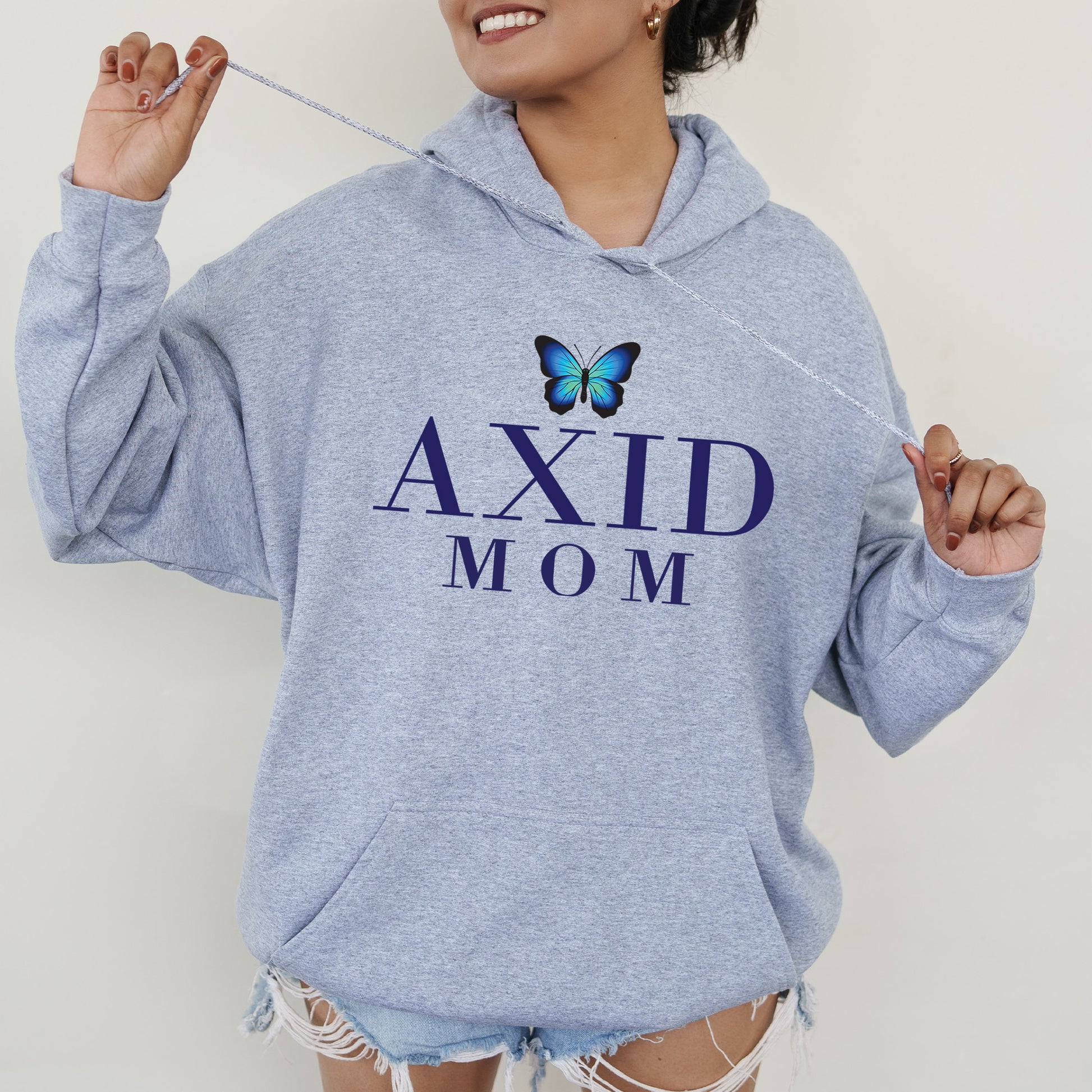 a woman wearing a blue hoodie with a butterfly on it