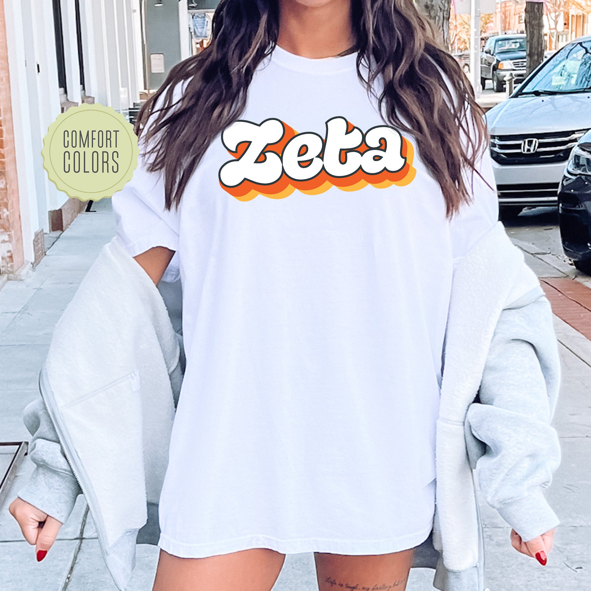 a woman wearing a white shirt with the word zeba on it