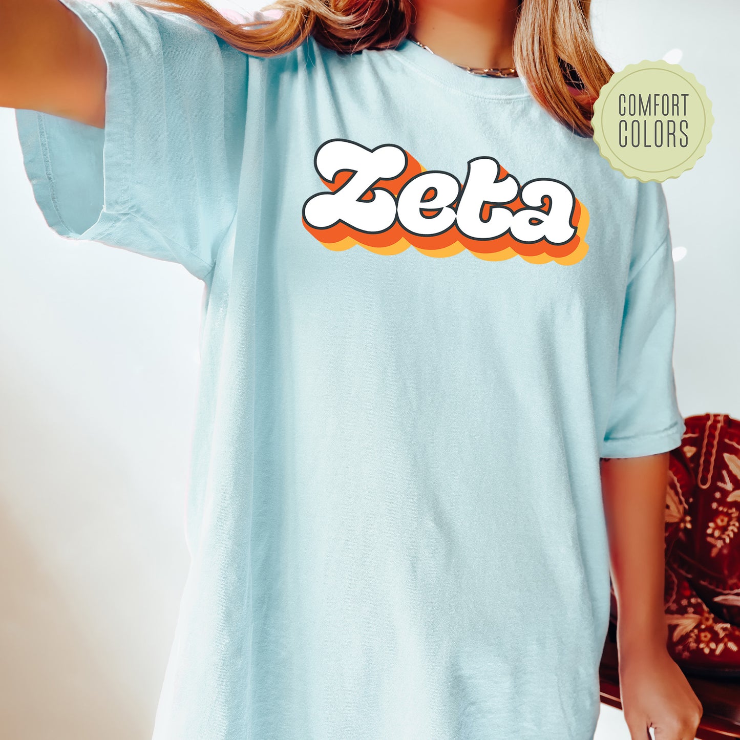 a woman wearing a blue shirt with the word zeta on it