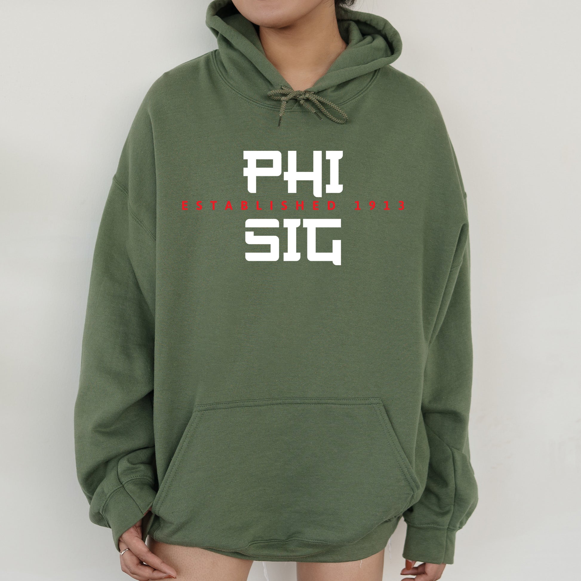 a person wearing a green hoodie with the words phi on it