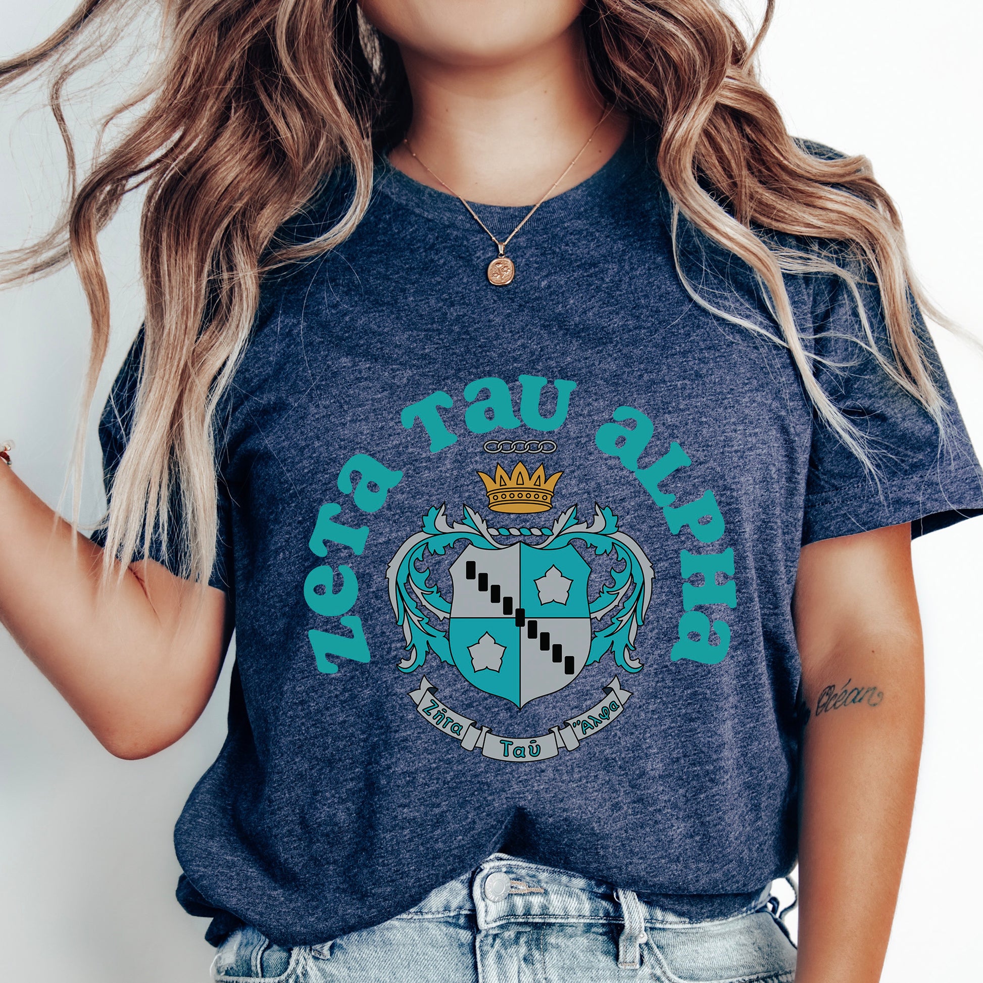 a woman wearing a blue shirt with a crown on it