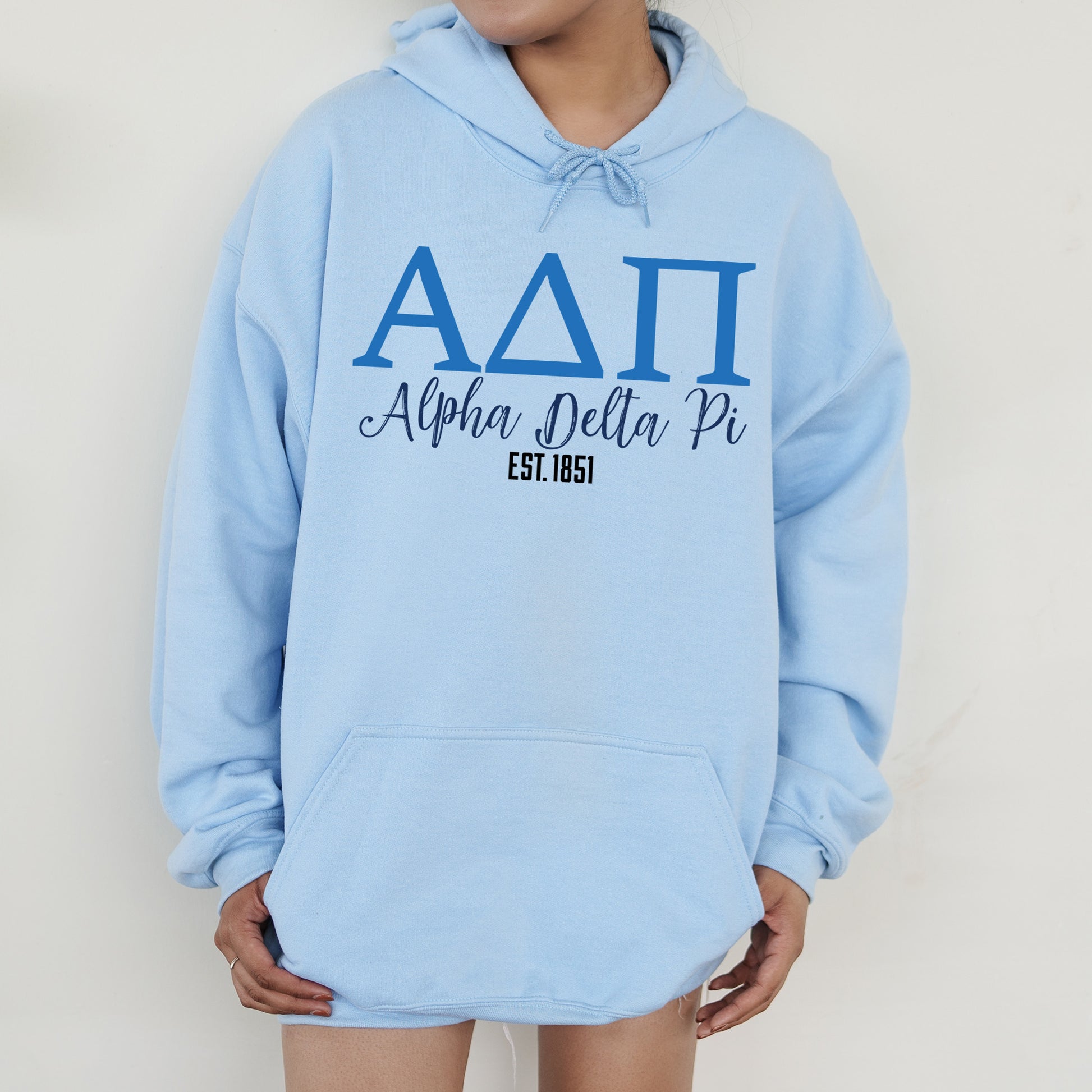a woman wearing a blue hoodie that says aati aloha pella