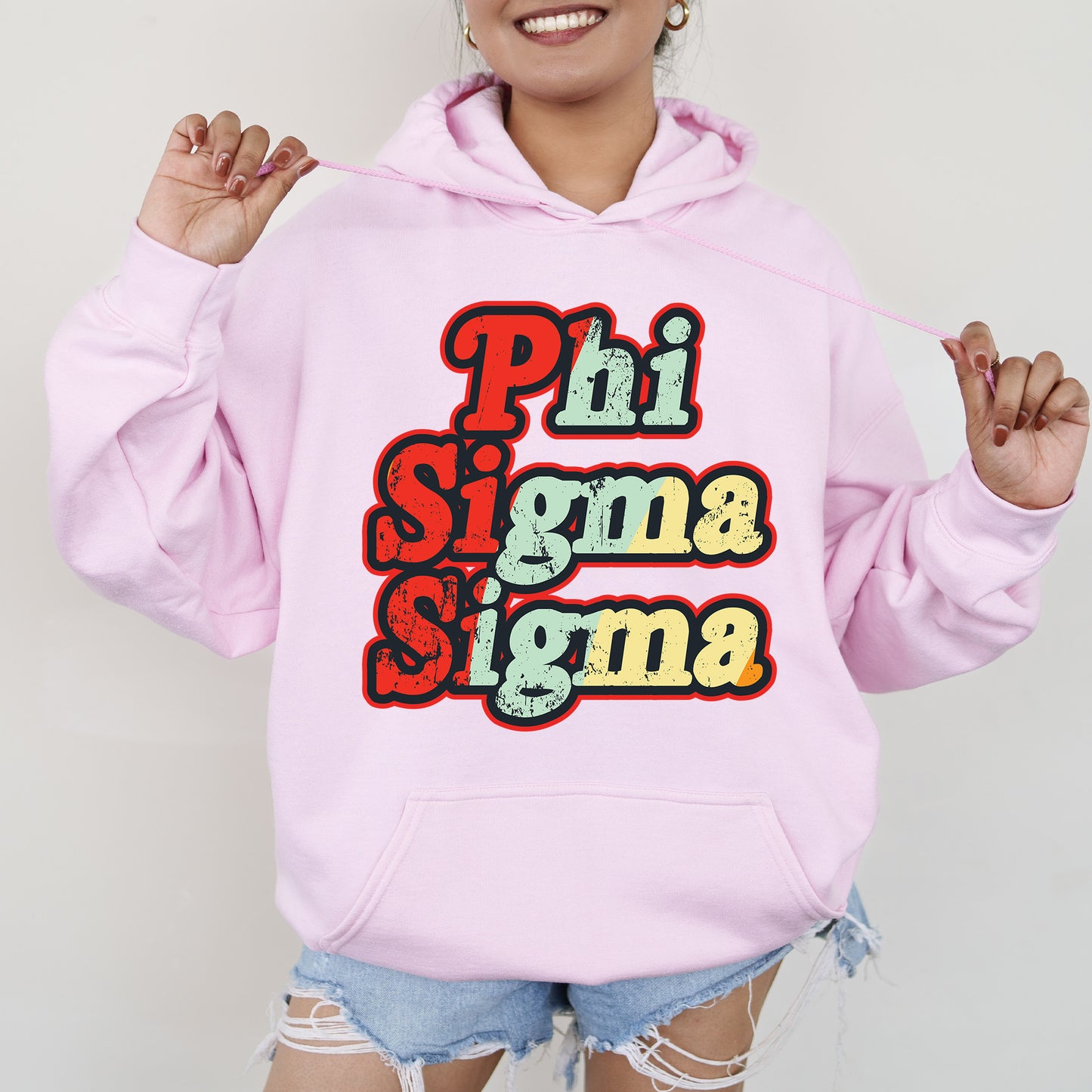 a woman wearing a pink hoodie that says phi sigmama