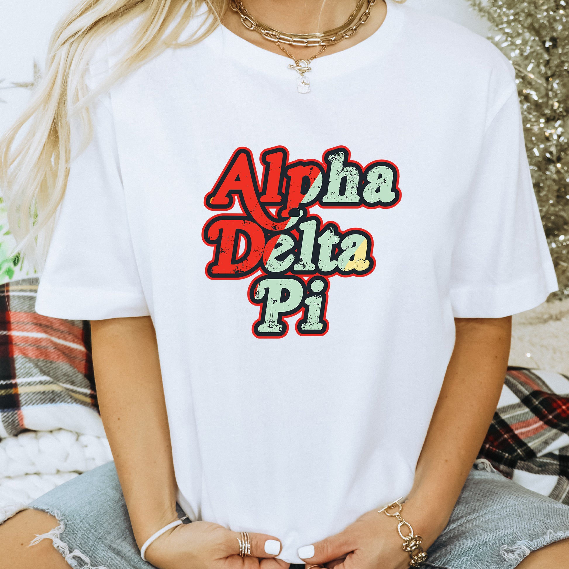 a woman wearing a white shirt with the words aloh delta pi on it