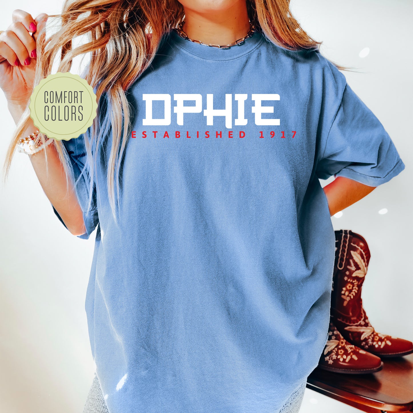 a woman in a blue shirt holding a skateboard