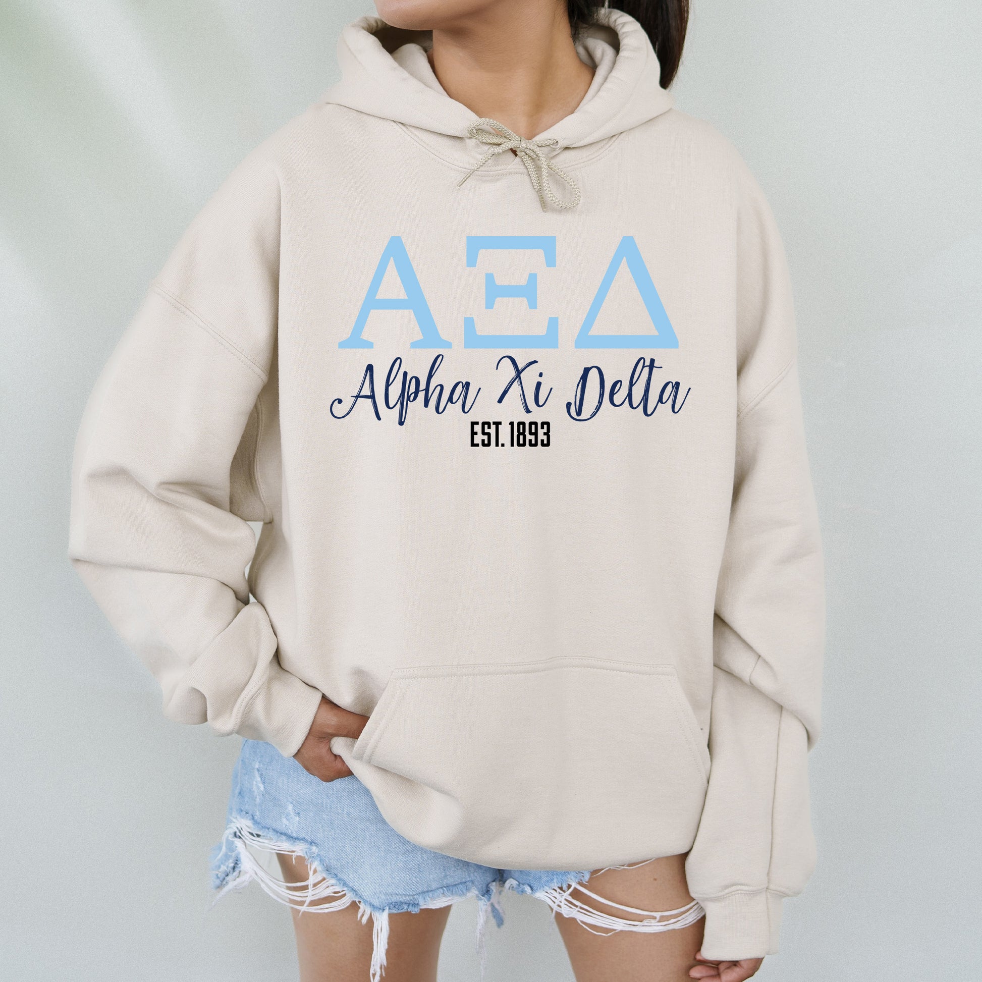 a woman wearing a hoodie with the letters aea on it