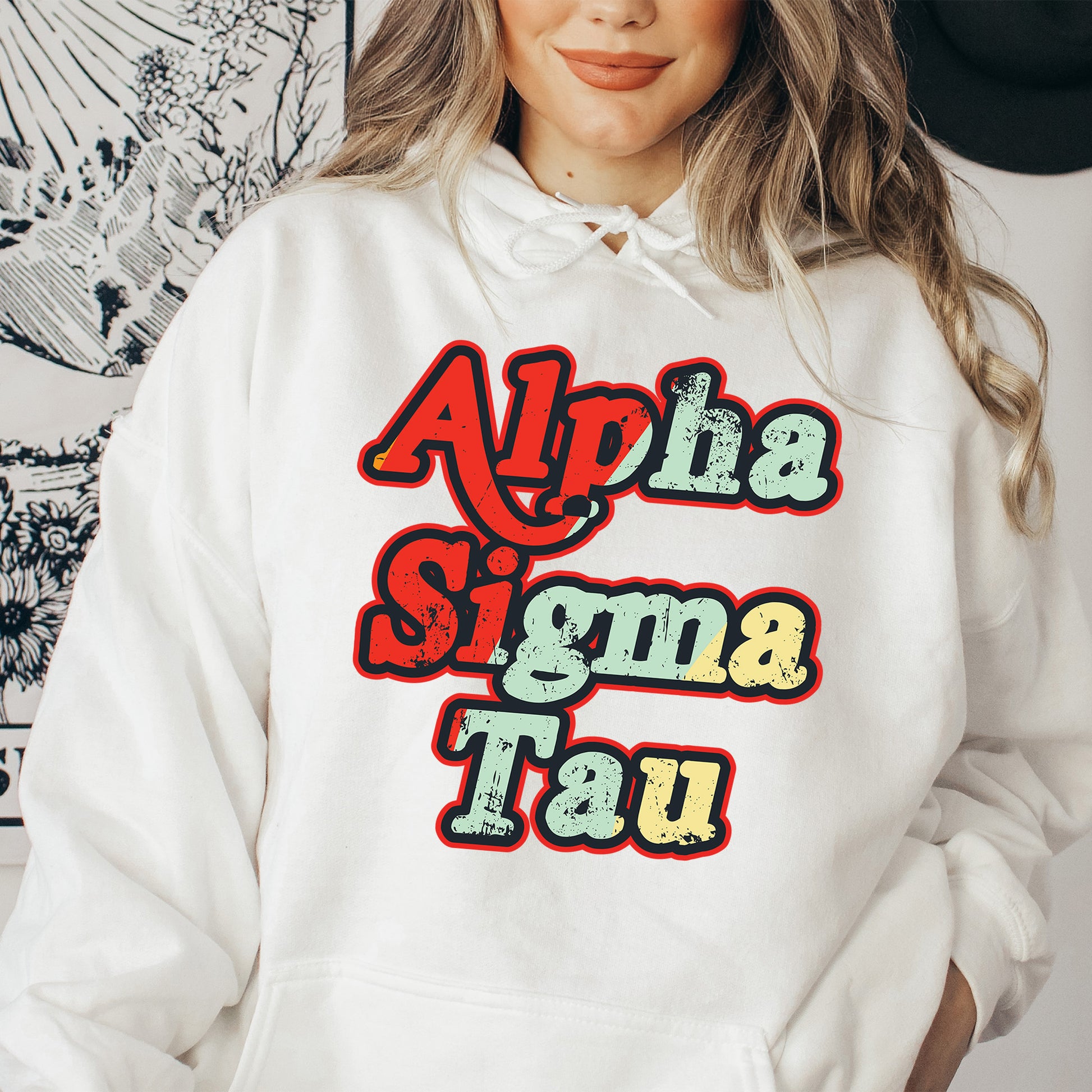 a woman wearing a white hoodie with the words aloh sigmama tau